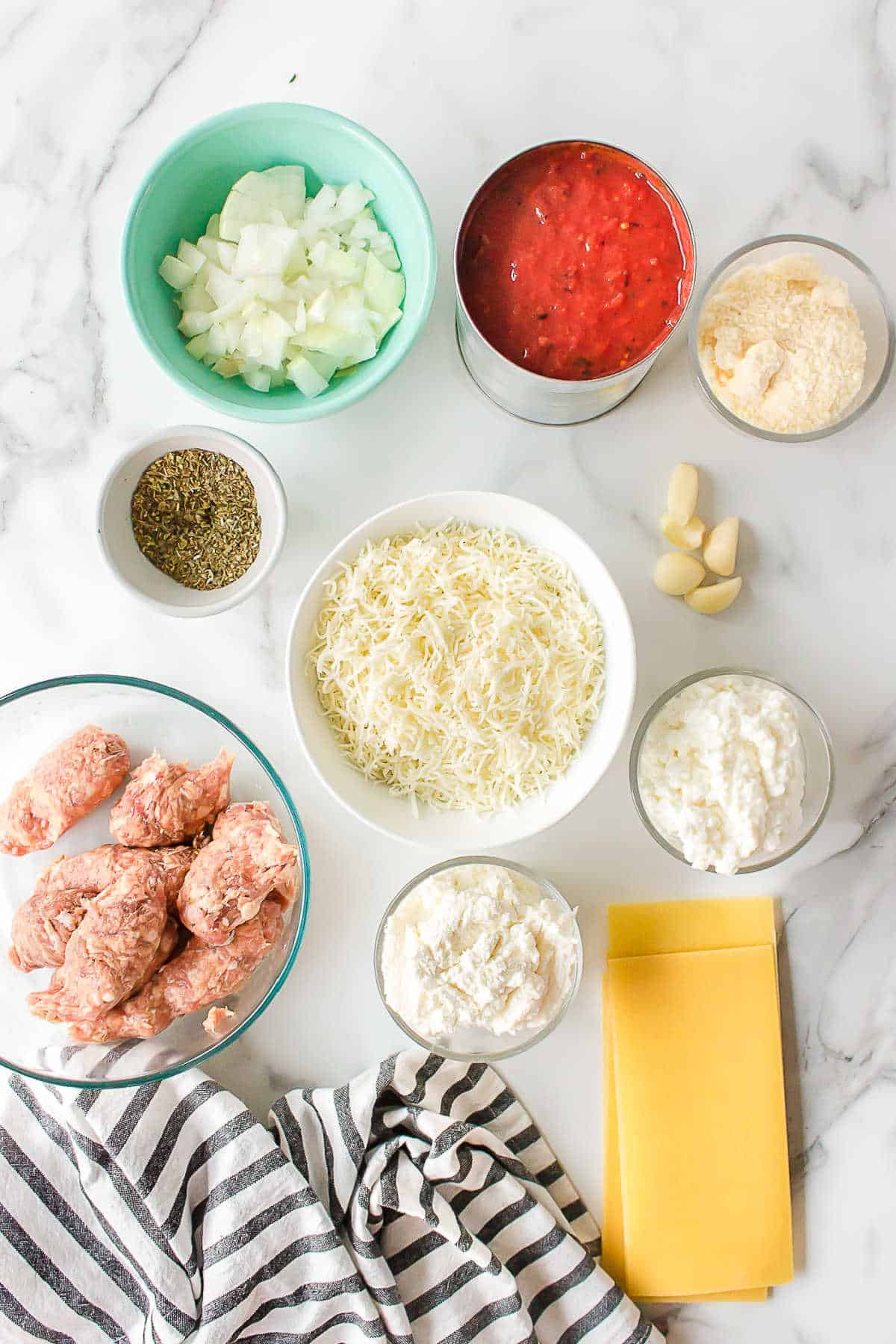 Ingredients for crock pot lasagna in dishes.