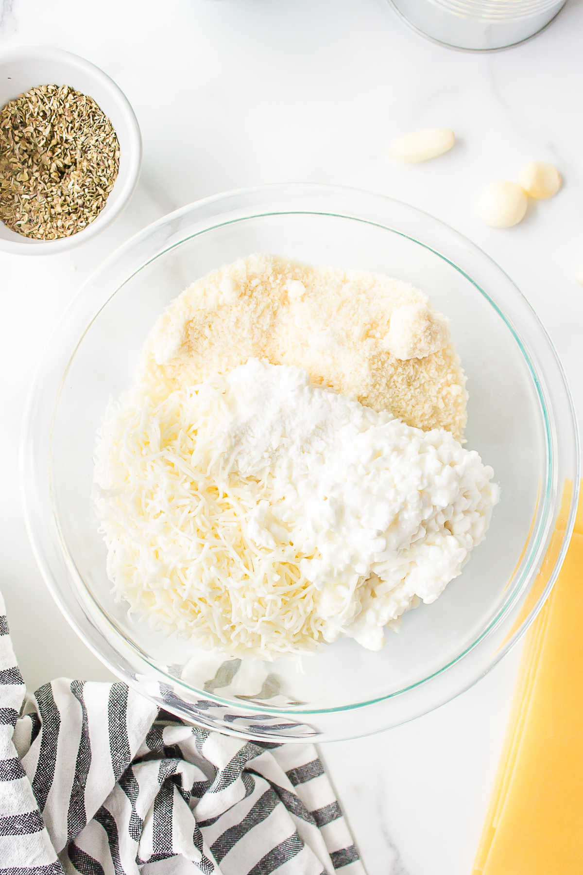 Parmesan ricotta and cottage cheese in a glass mixing bowl. 