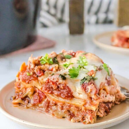 Slice of crock pot lasagna on a white plate.