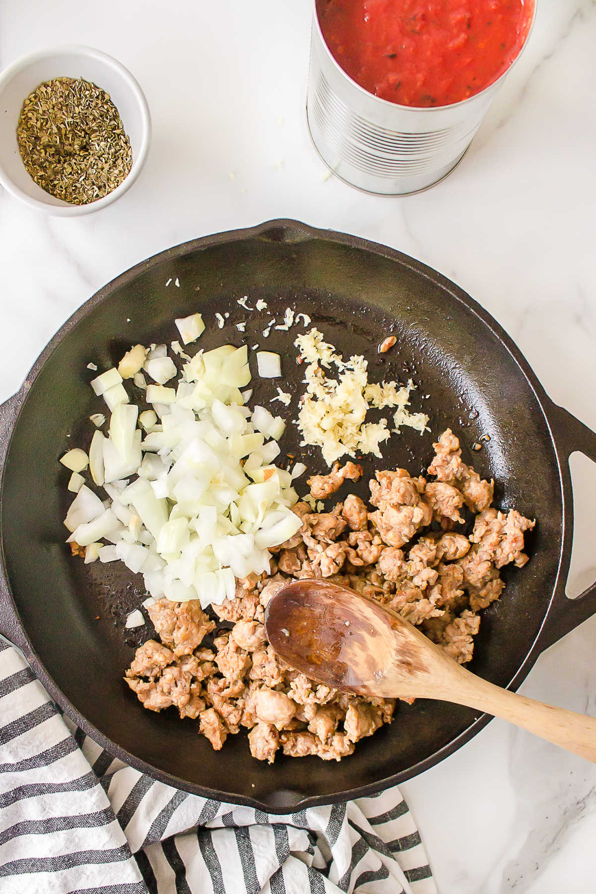 Italian sausage and onion in a skillet. 