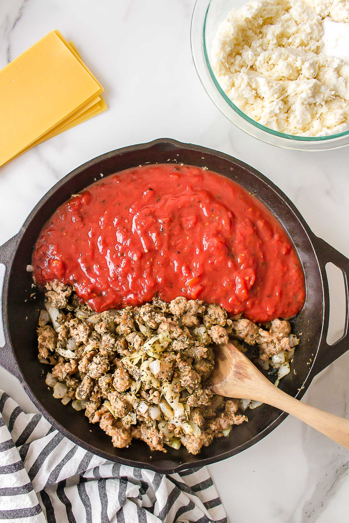 Tomatoes and Italian sausage in a skillet. 