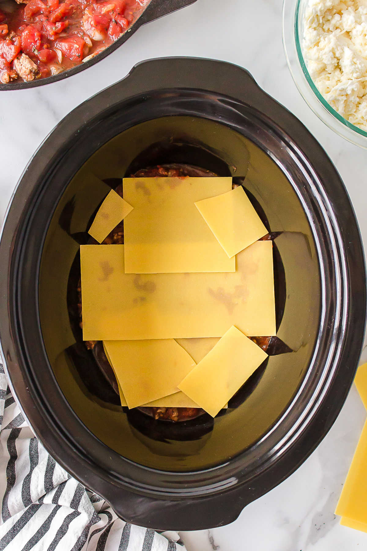 Broken lasagna noodles in a slow cooker.