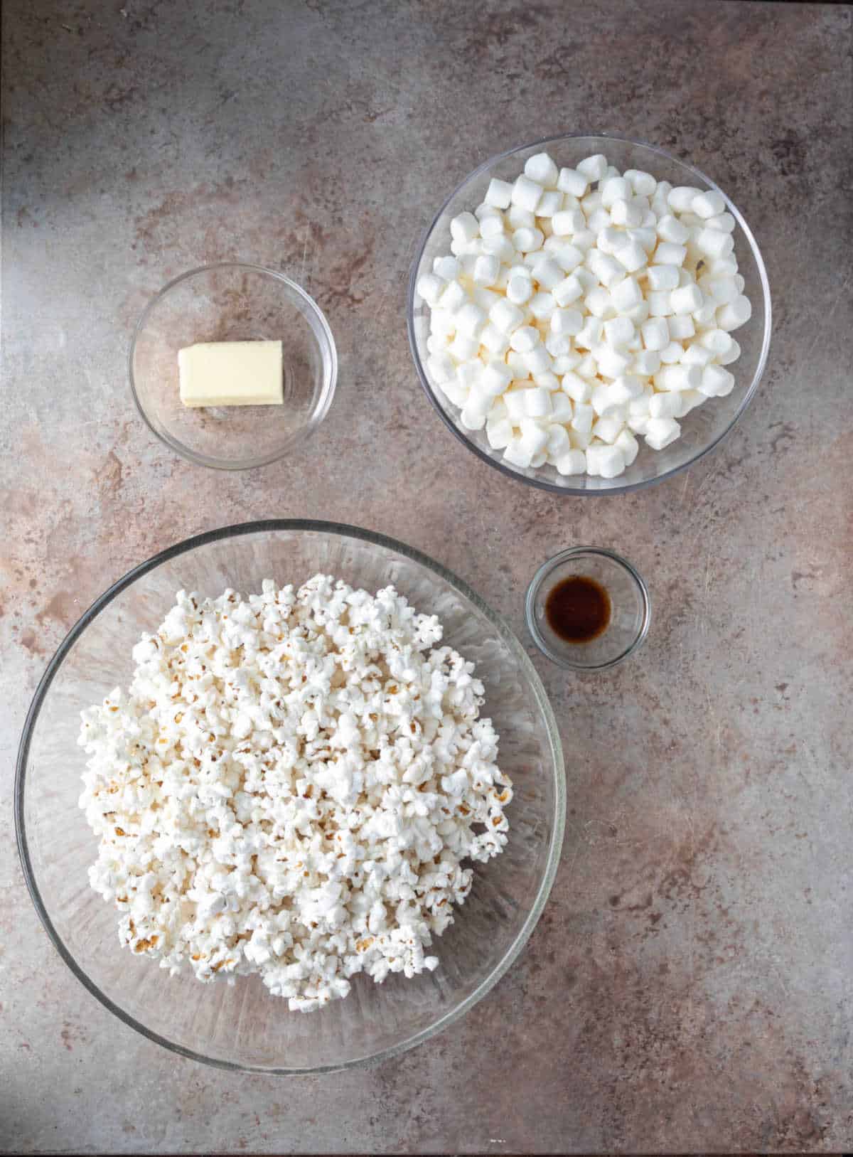 Popcorn marshmallows and butter in dishes. 