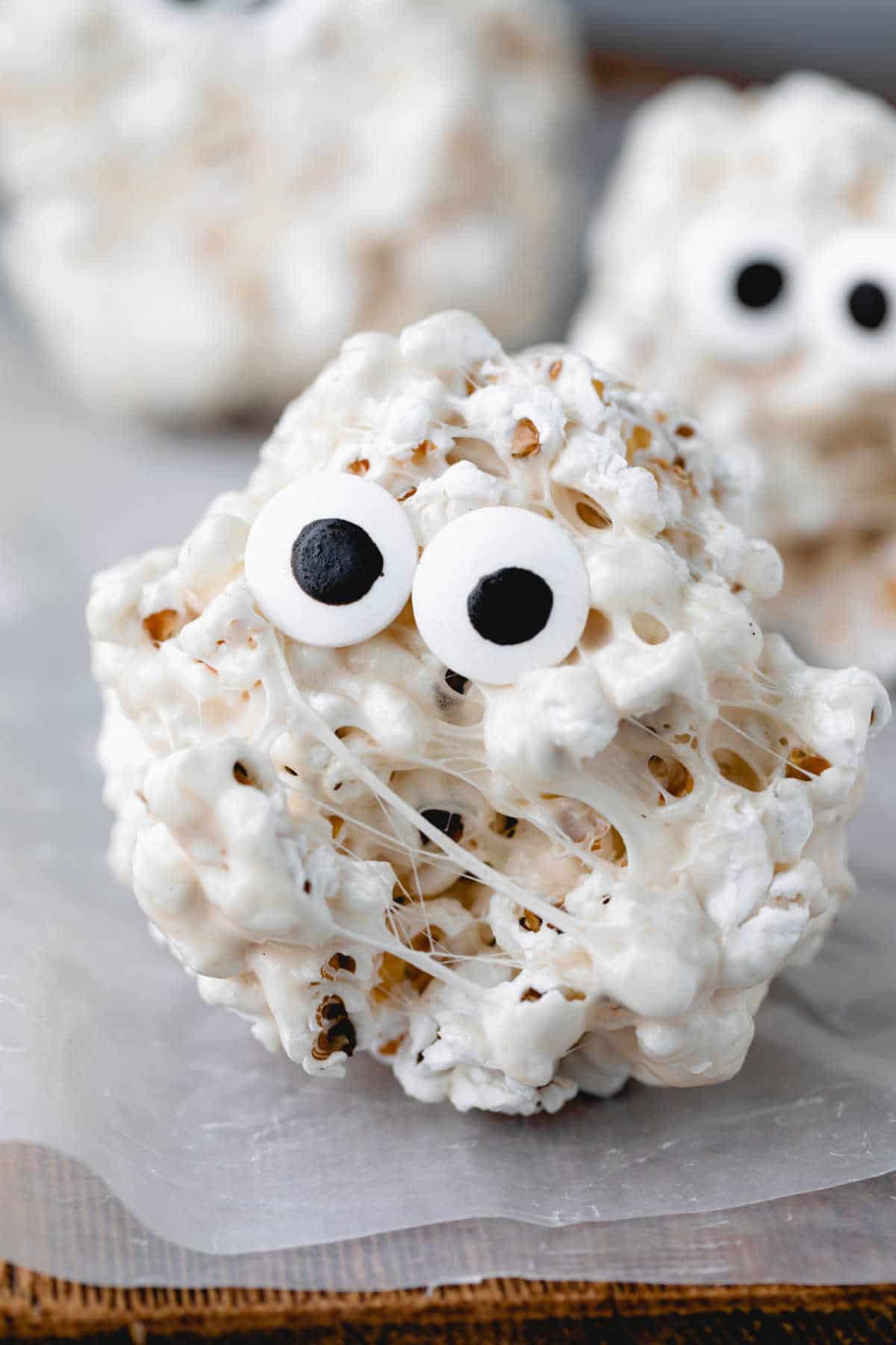 Popcorn ball with candy eyes on it. 