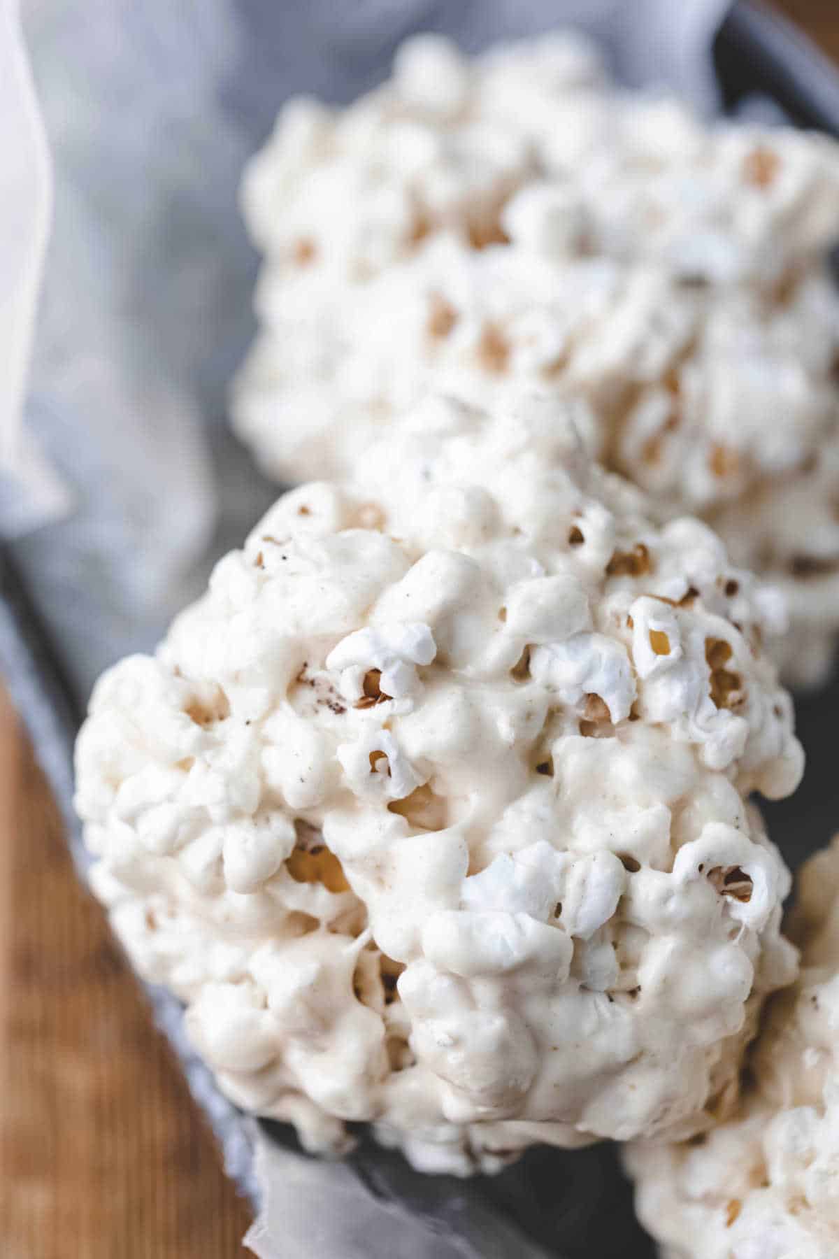 Popcorn ball in a metal dish.