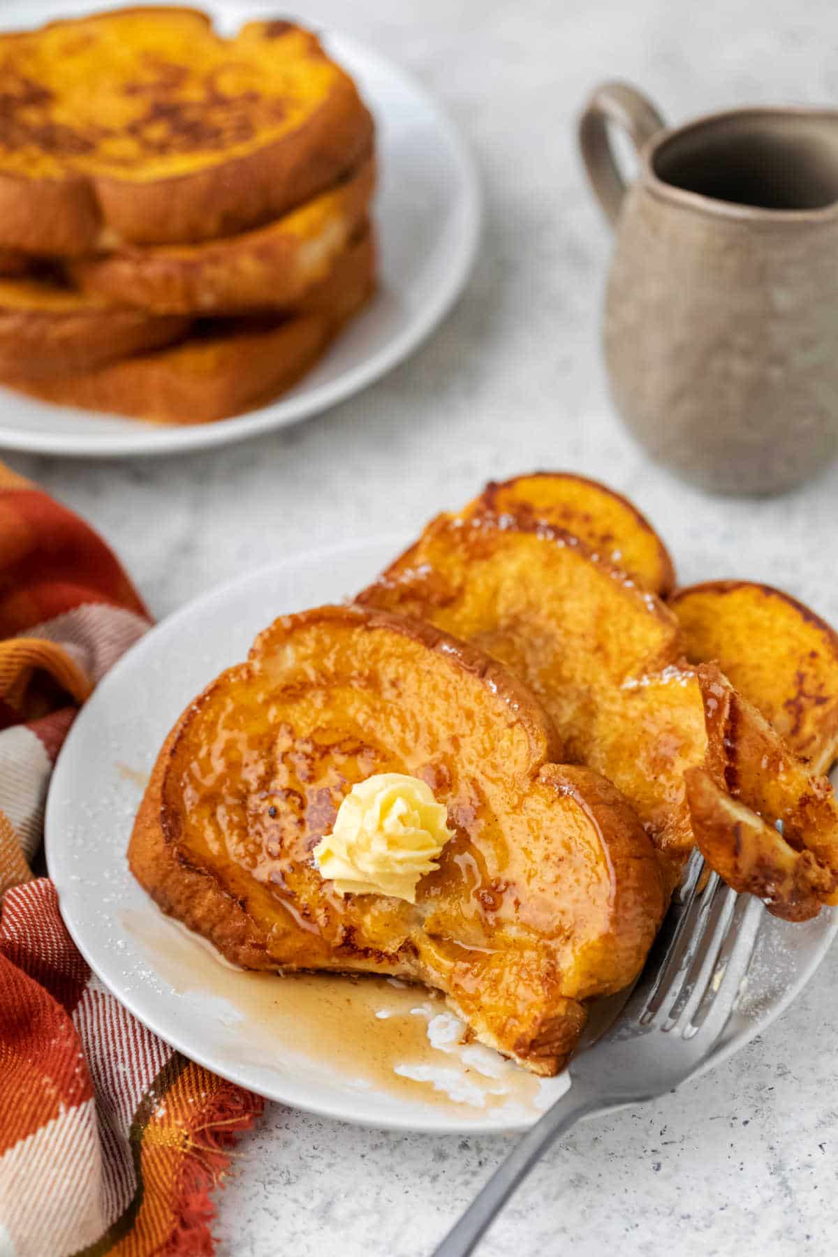 Slices of pumpkin French toast with a bite missing. 