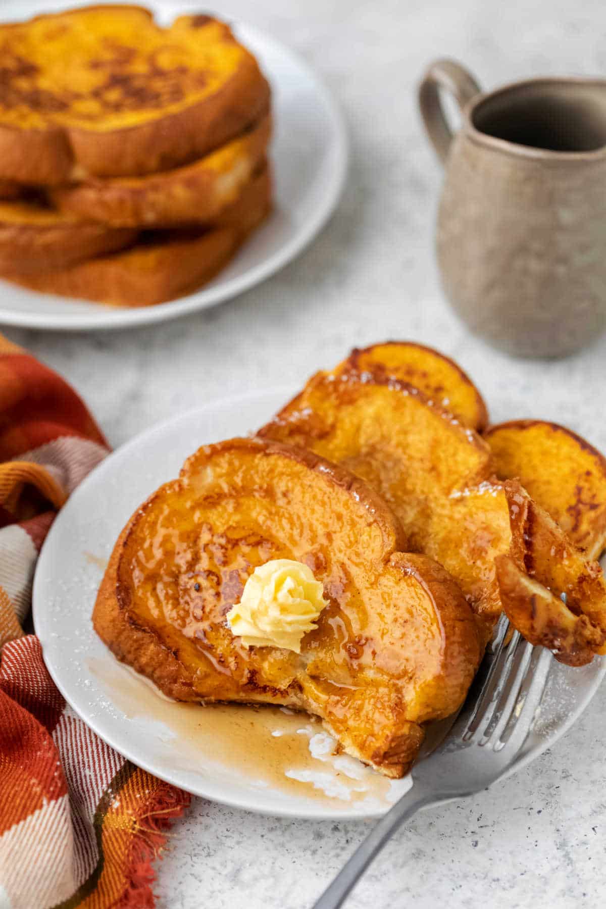 Slices of pumpkin French toast with a bite missing.