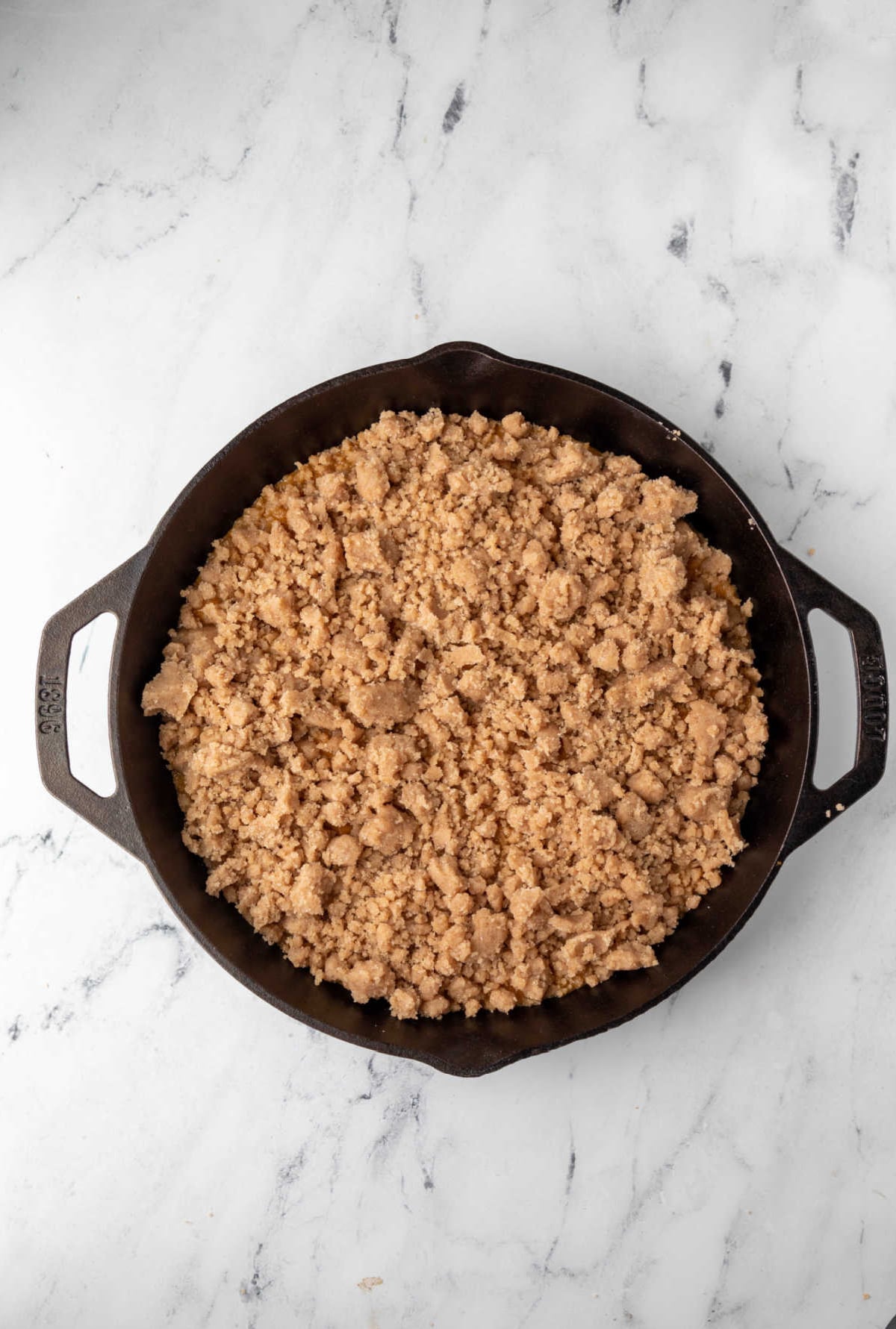 Unbaked pumpkin crisp in a cast iron skillet.