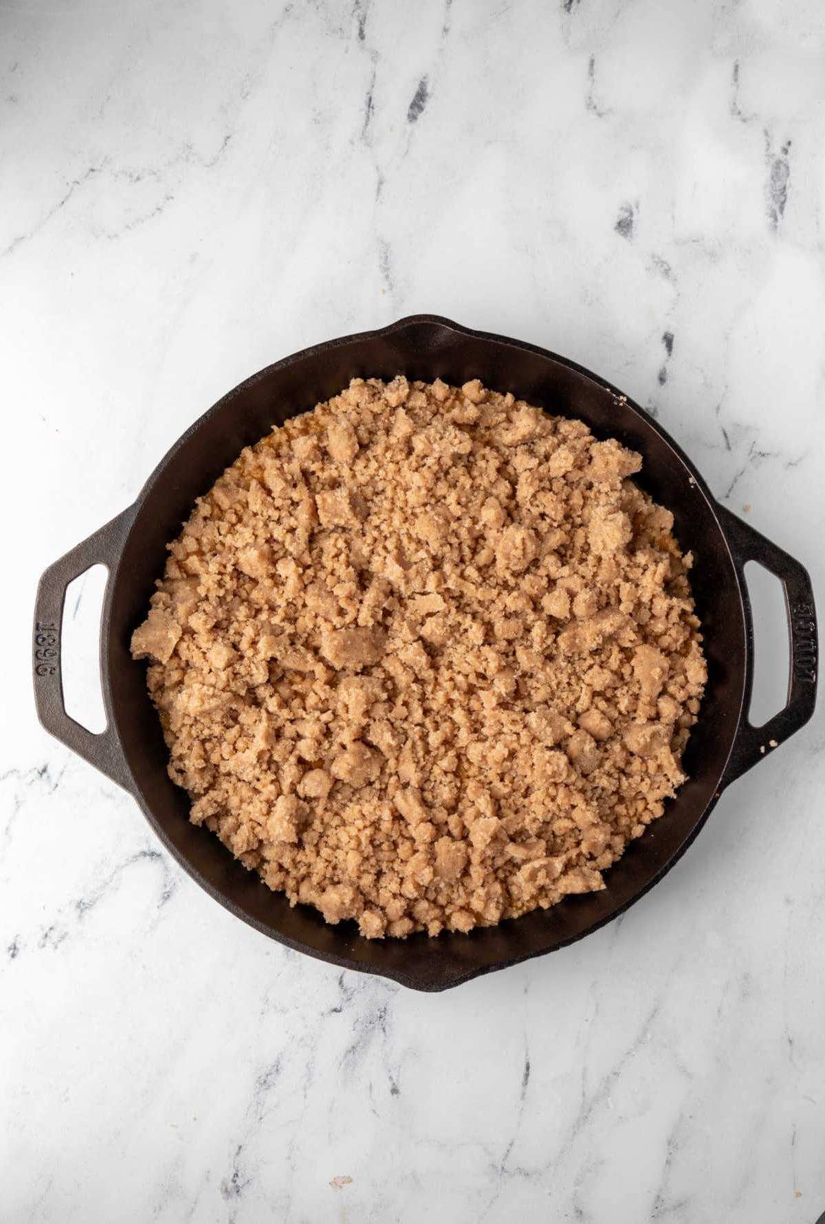 Unbaked pumpkin crisp in a cast iron skillet. 