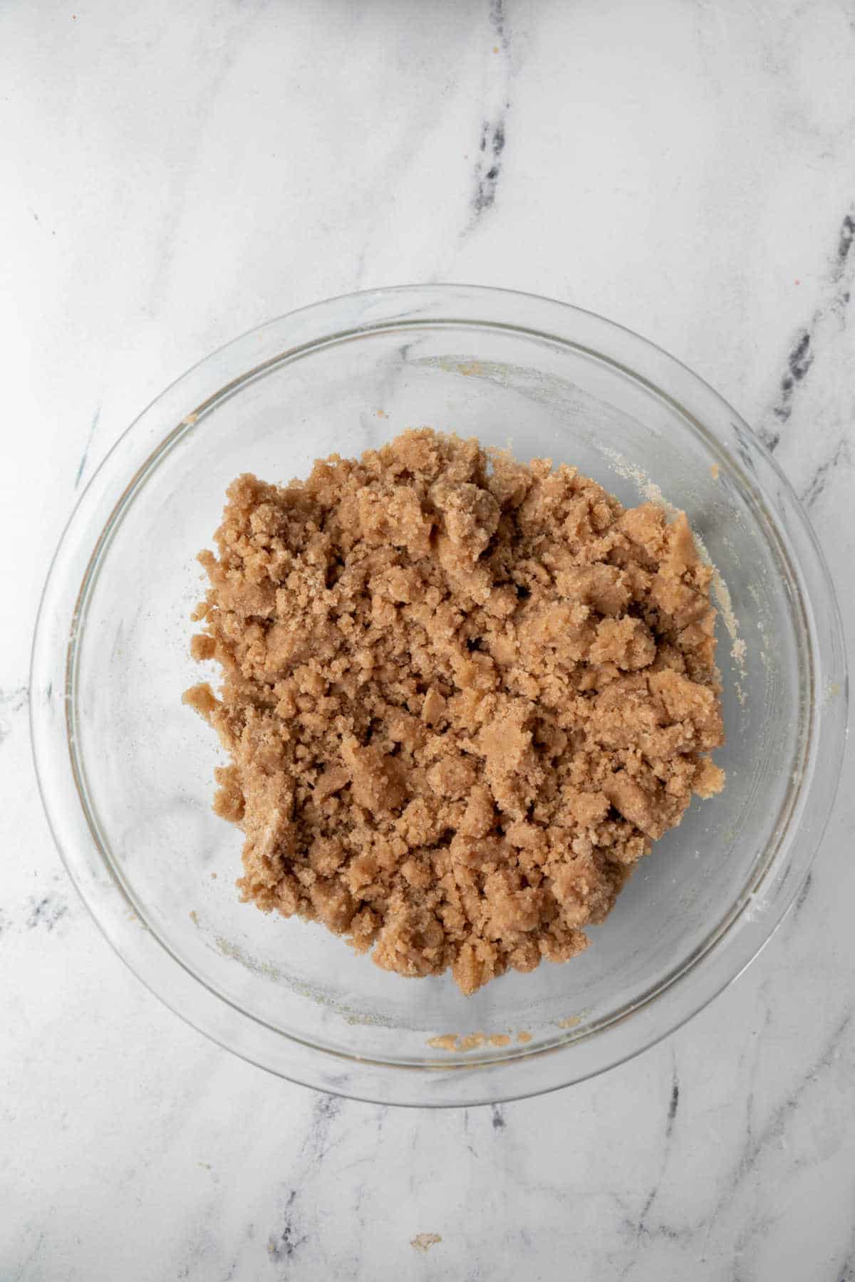 Unbaked crisp topping in a glass mixing bowl.