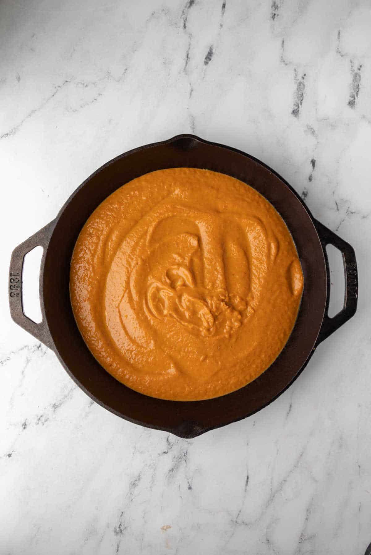 Pumpkin crisp filling in a cast iron skillet. 