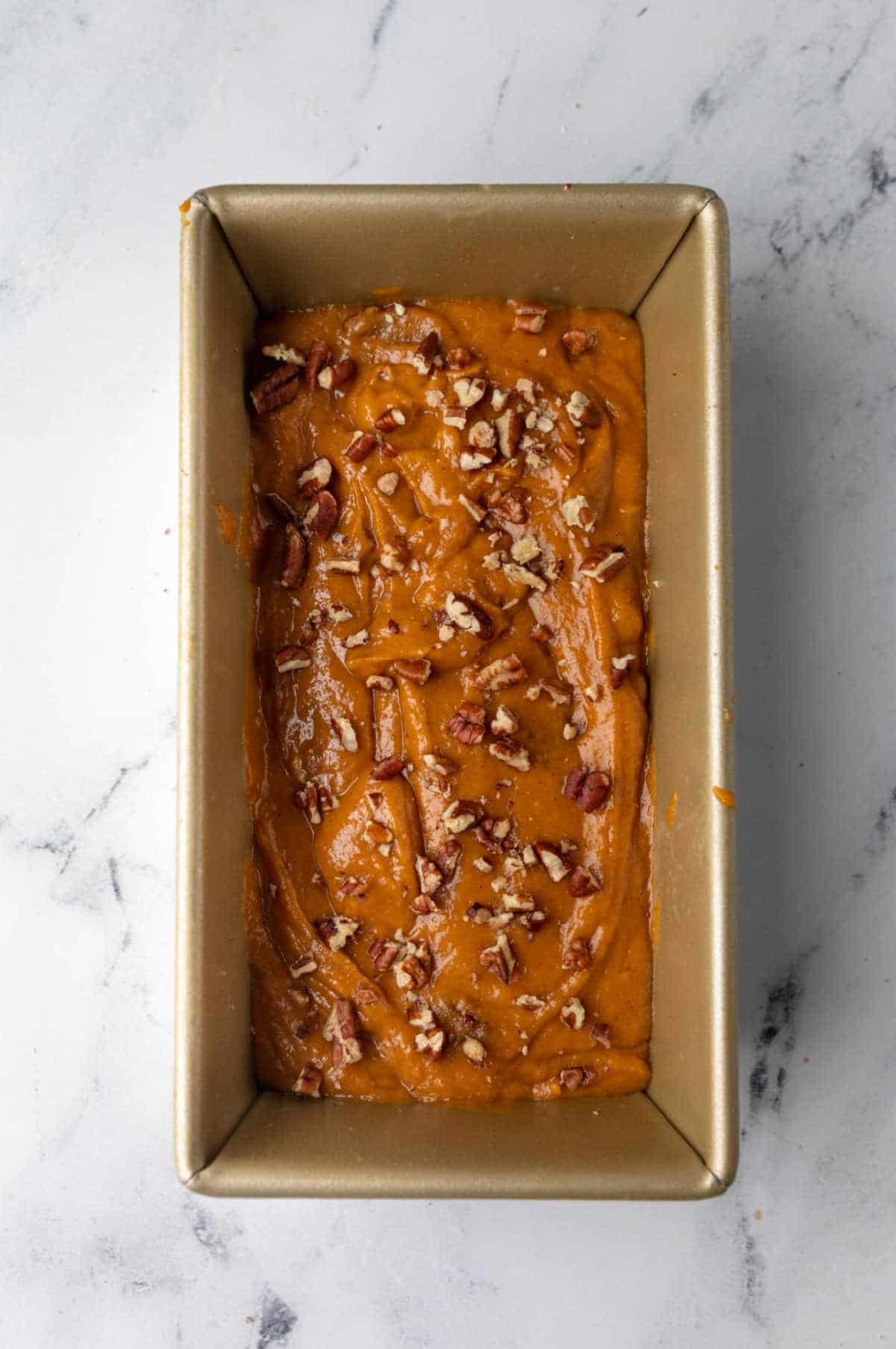 Pumpkin nut bread batter in a loaf pan.