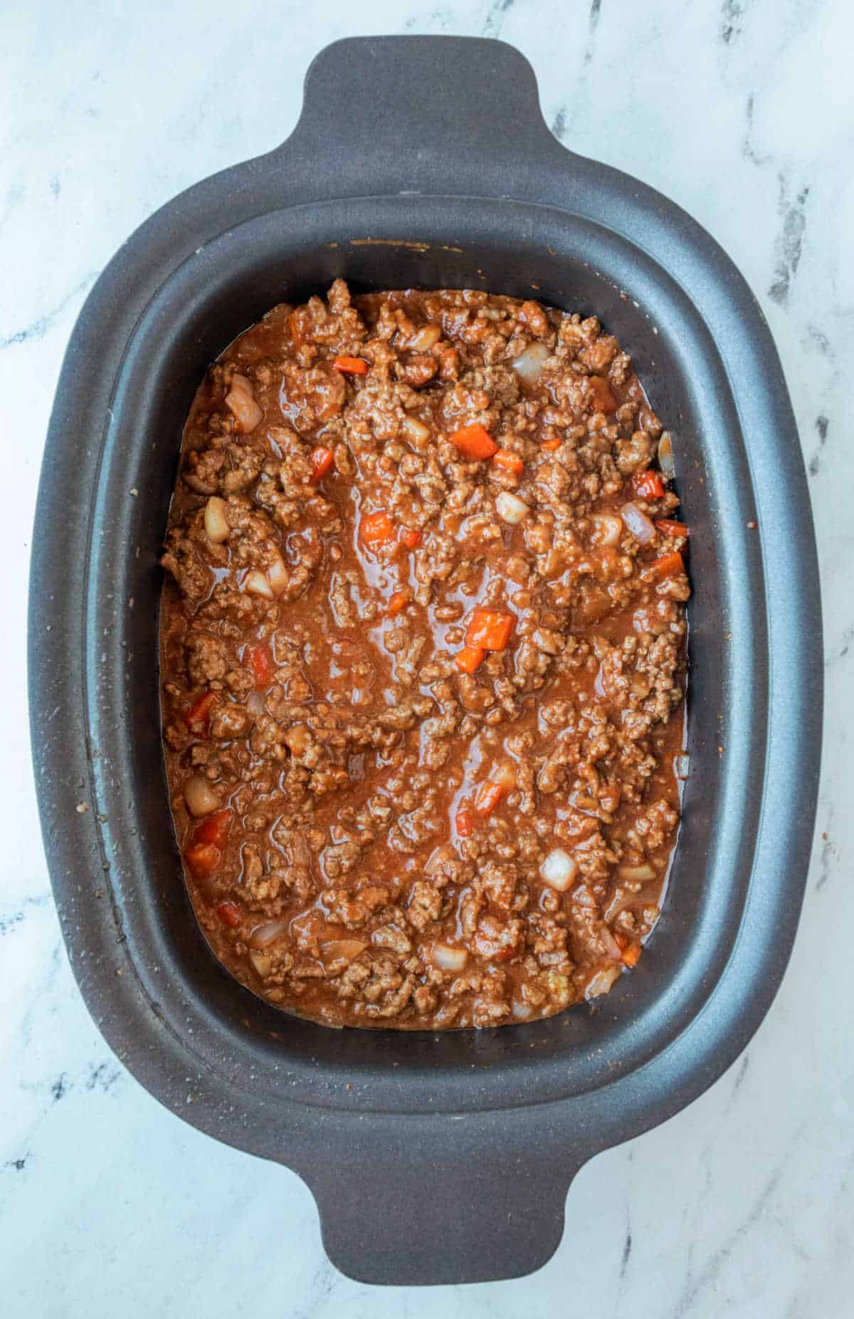 Sloppy Joe Mixture in a slow cooker insert. 