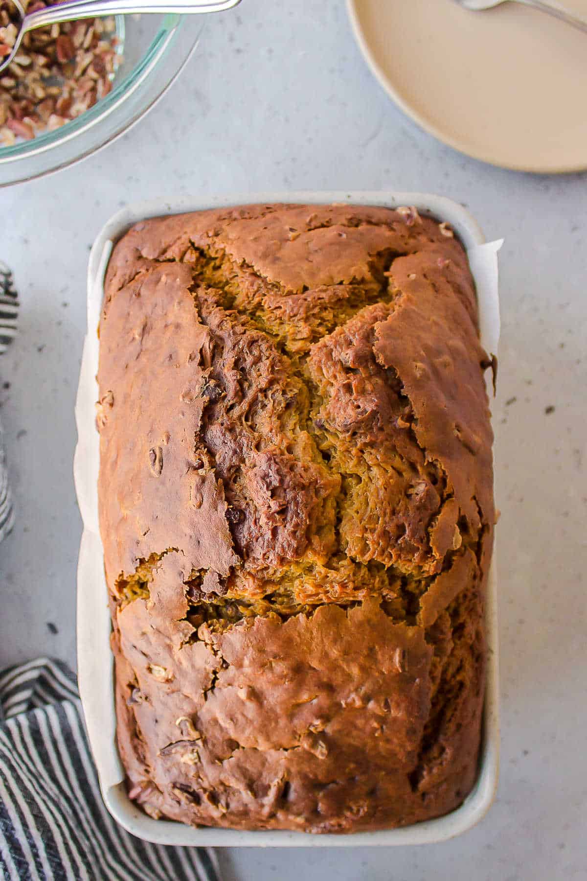 Baked loaf of pumpkin bread in a loaf pan.