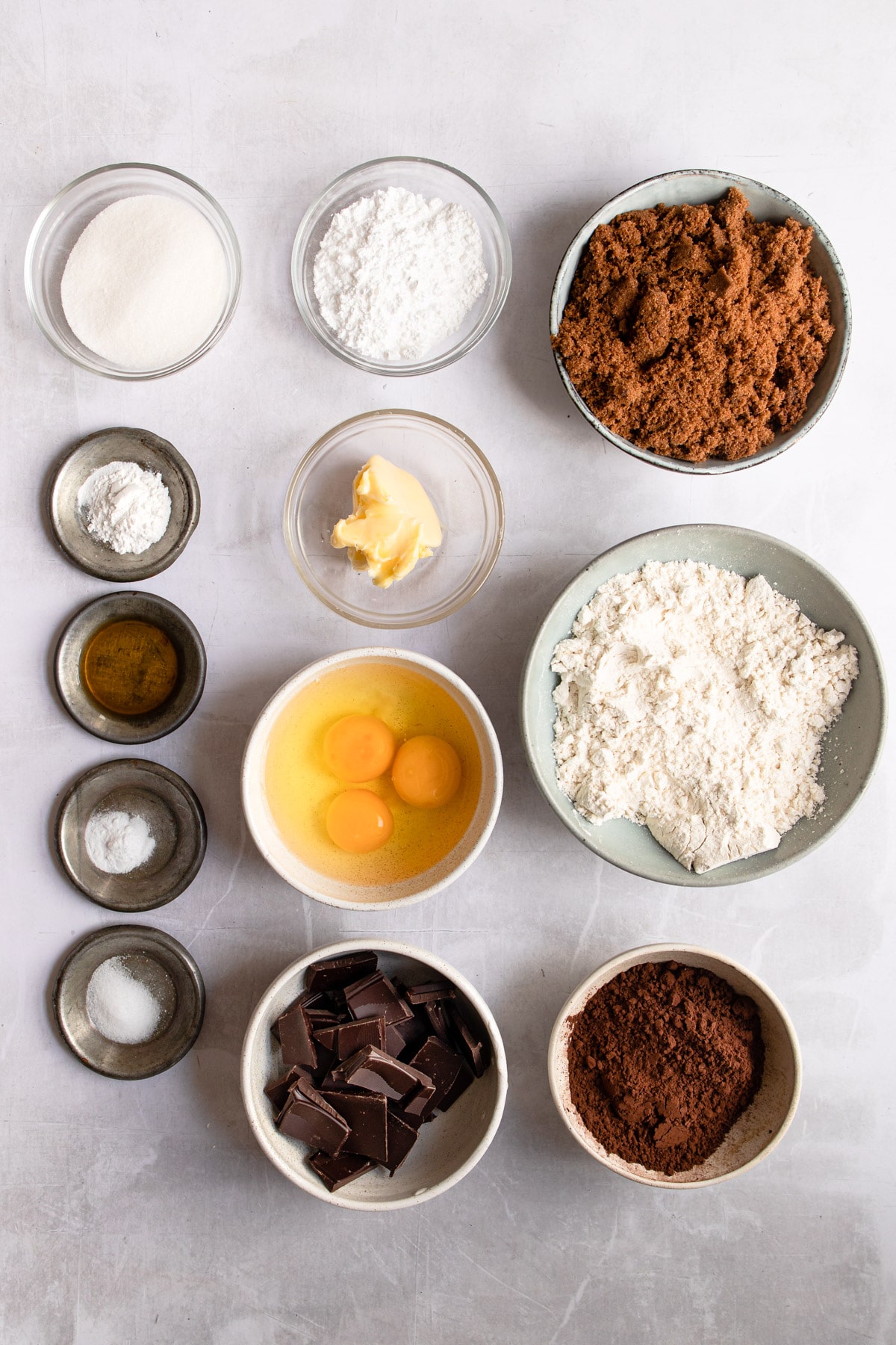 Ingredients for chocolate crinkle cookies in dishes. 