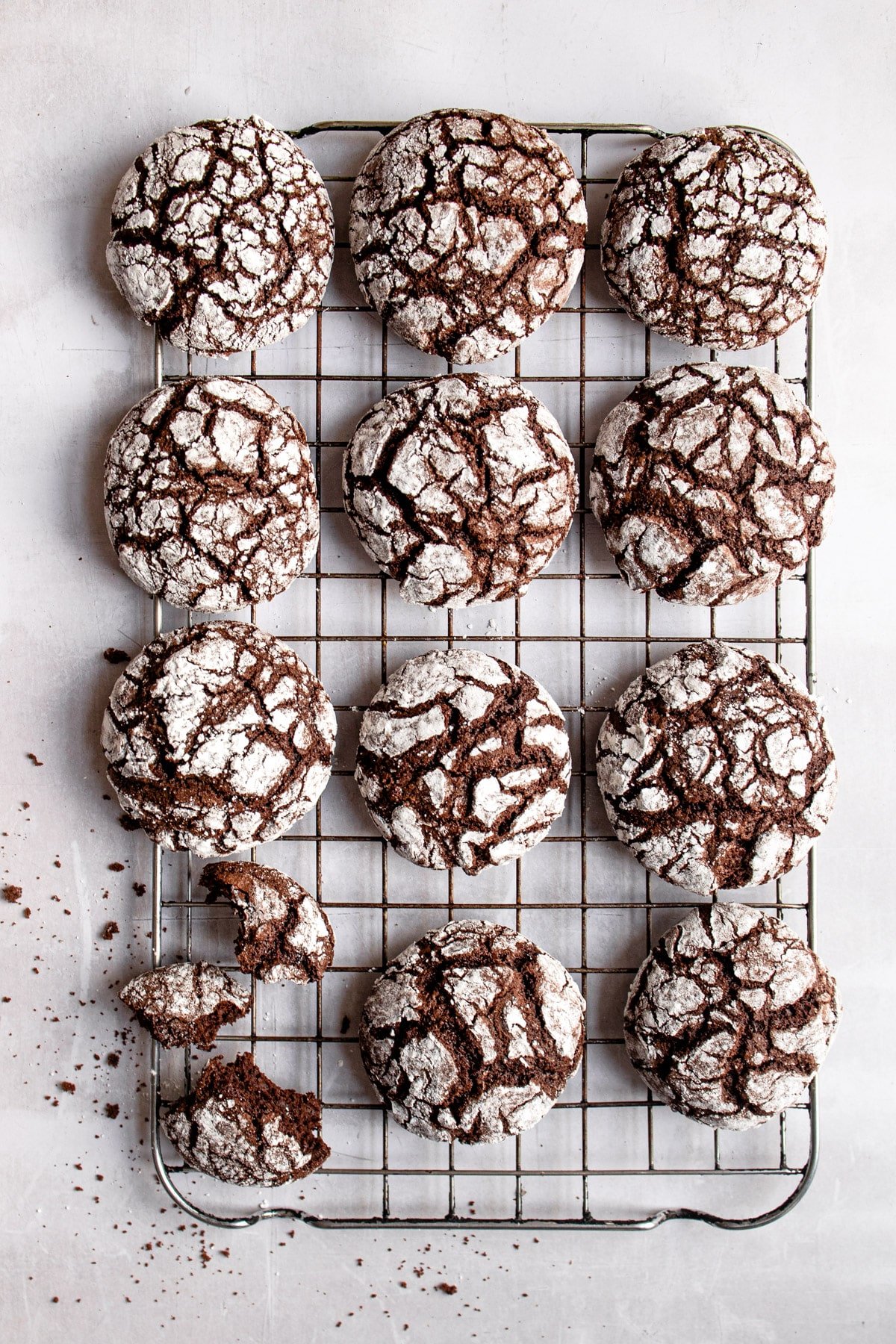 Chocolate crinkle cookies on a wire cooling rack.