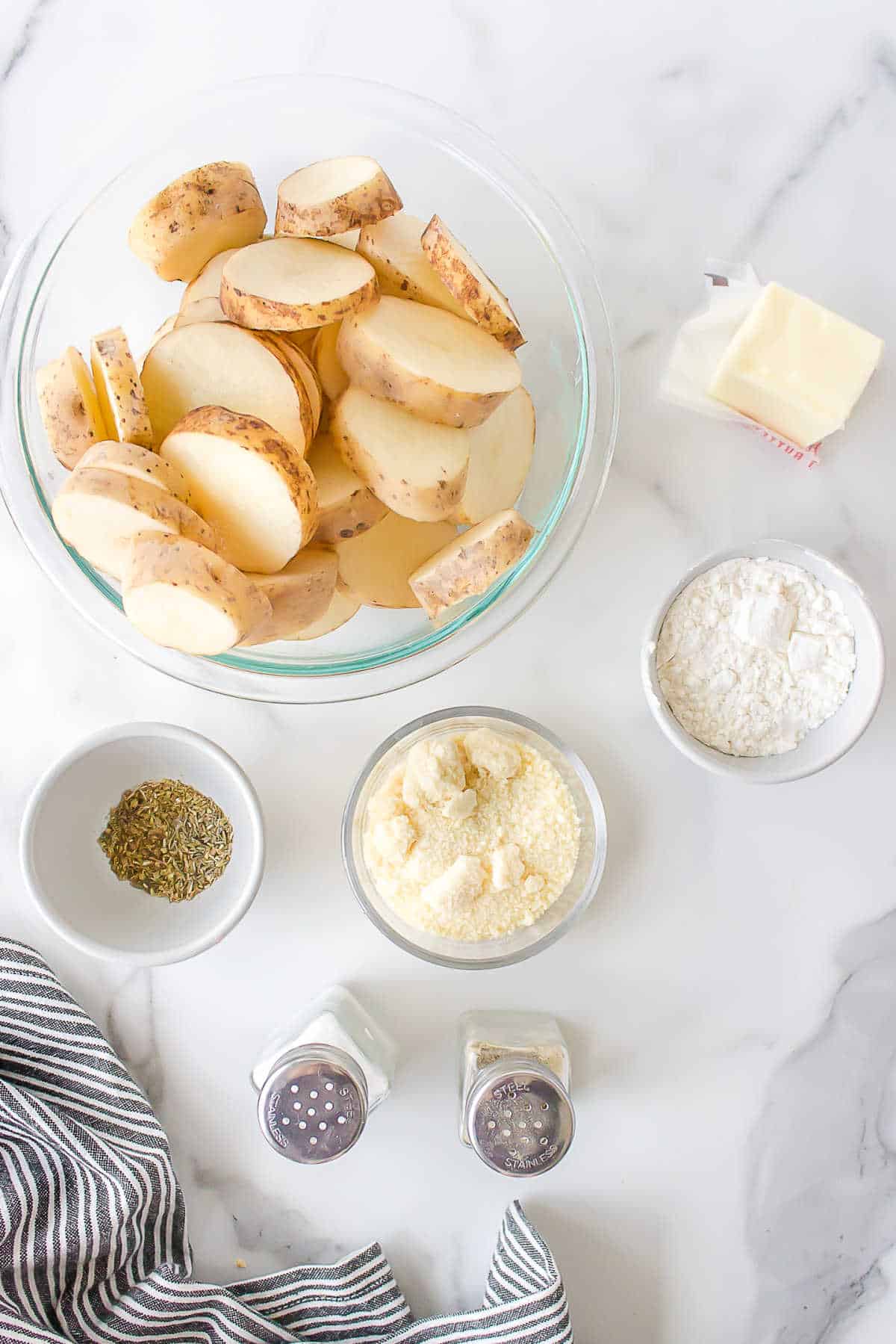 Ingredients for parmesan potatoes in dishes. 