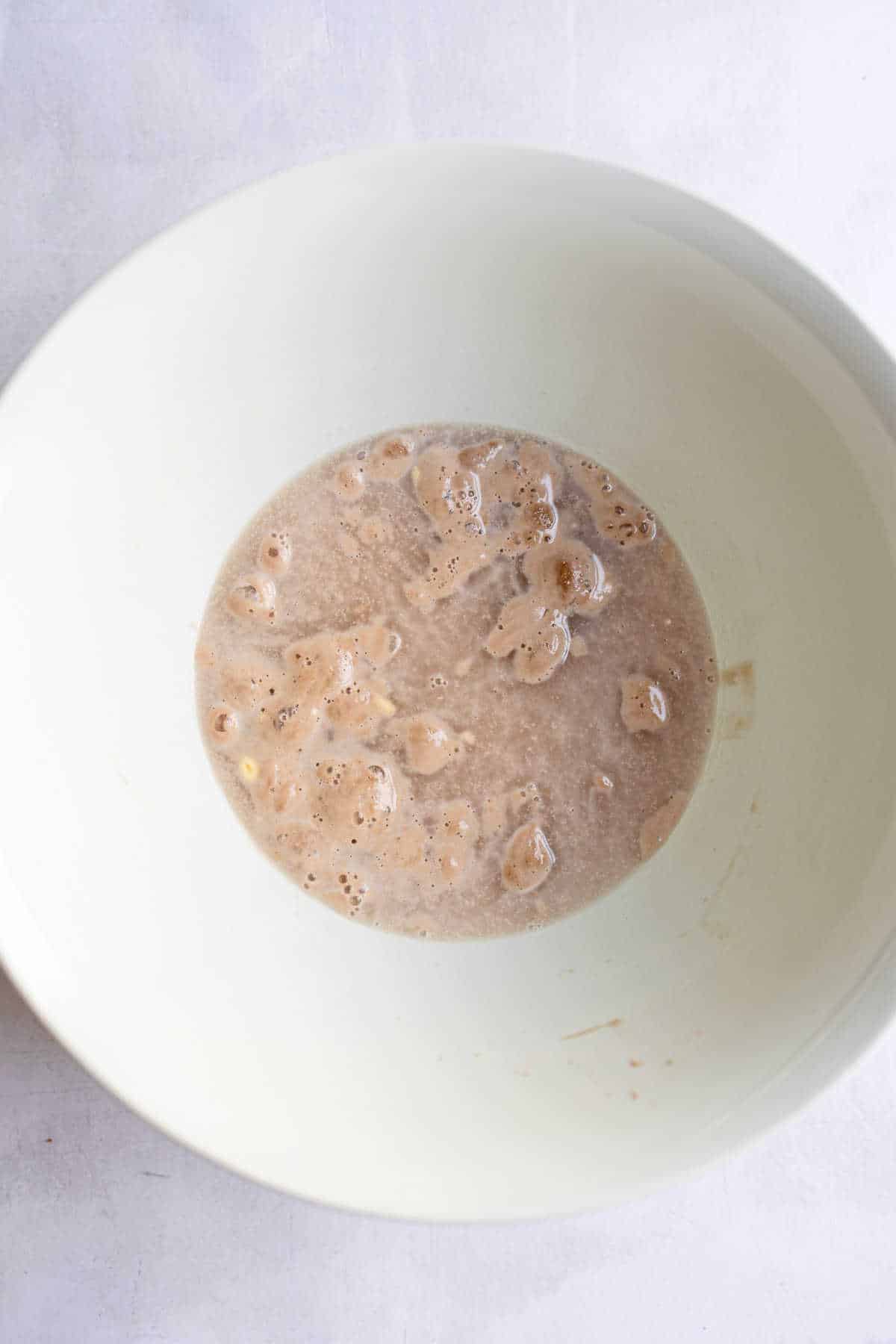 Yeast proofing in a white bowl. 