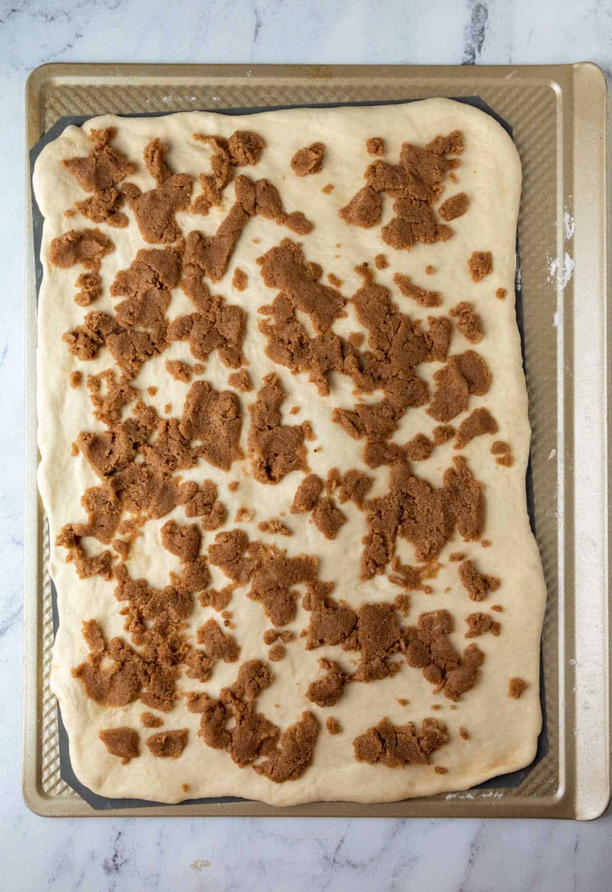 Filling spread over sticky bun dough.