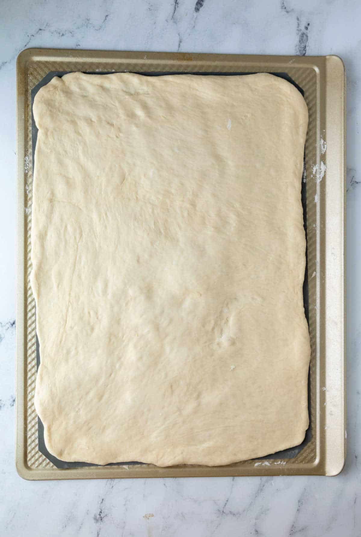 Sticky bun dough rolled into a rectangle.
