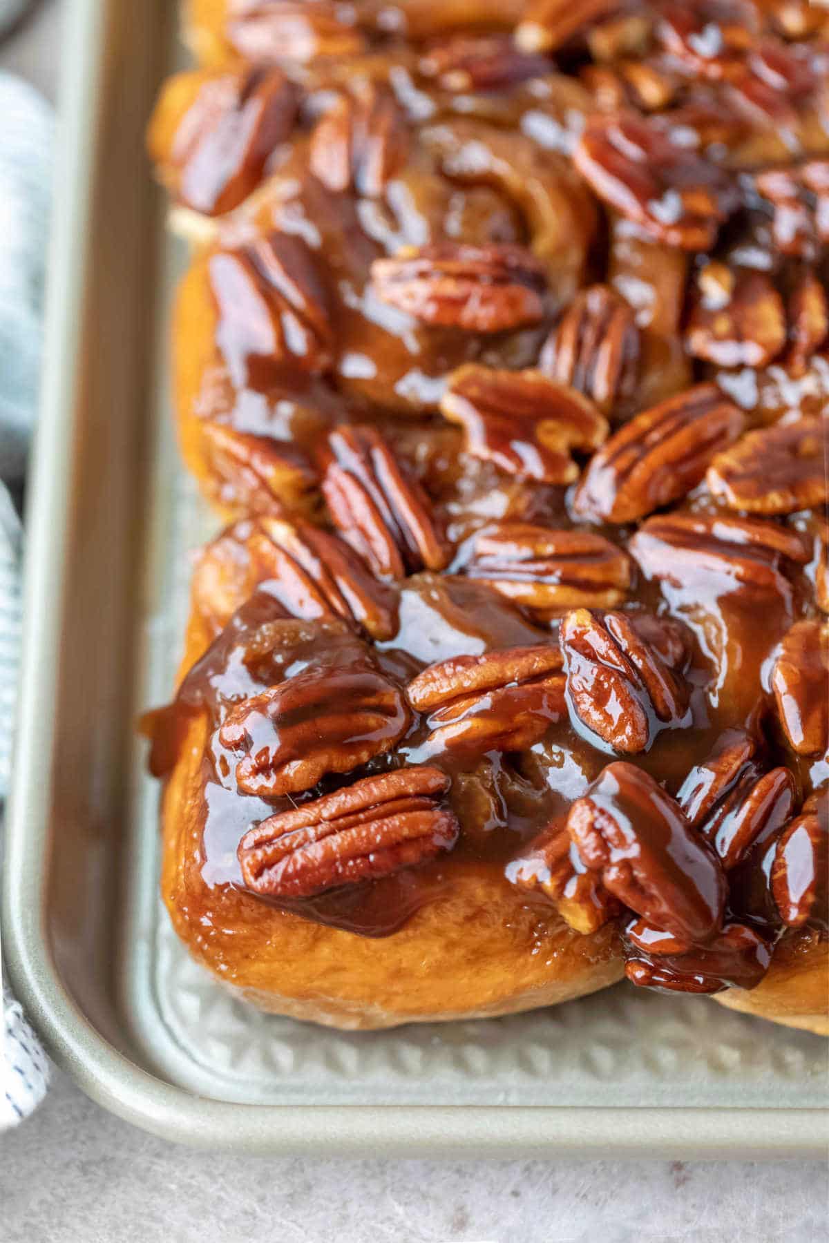 Front view of maple sticky buns on a tray.