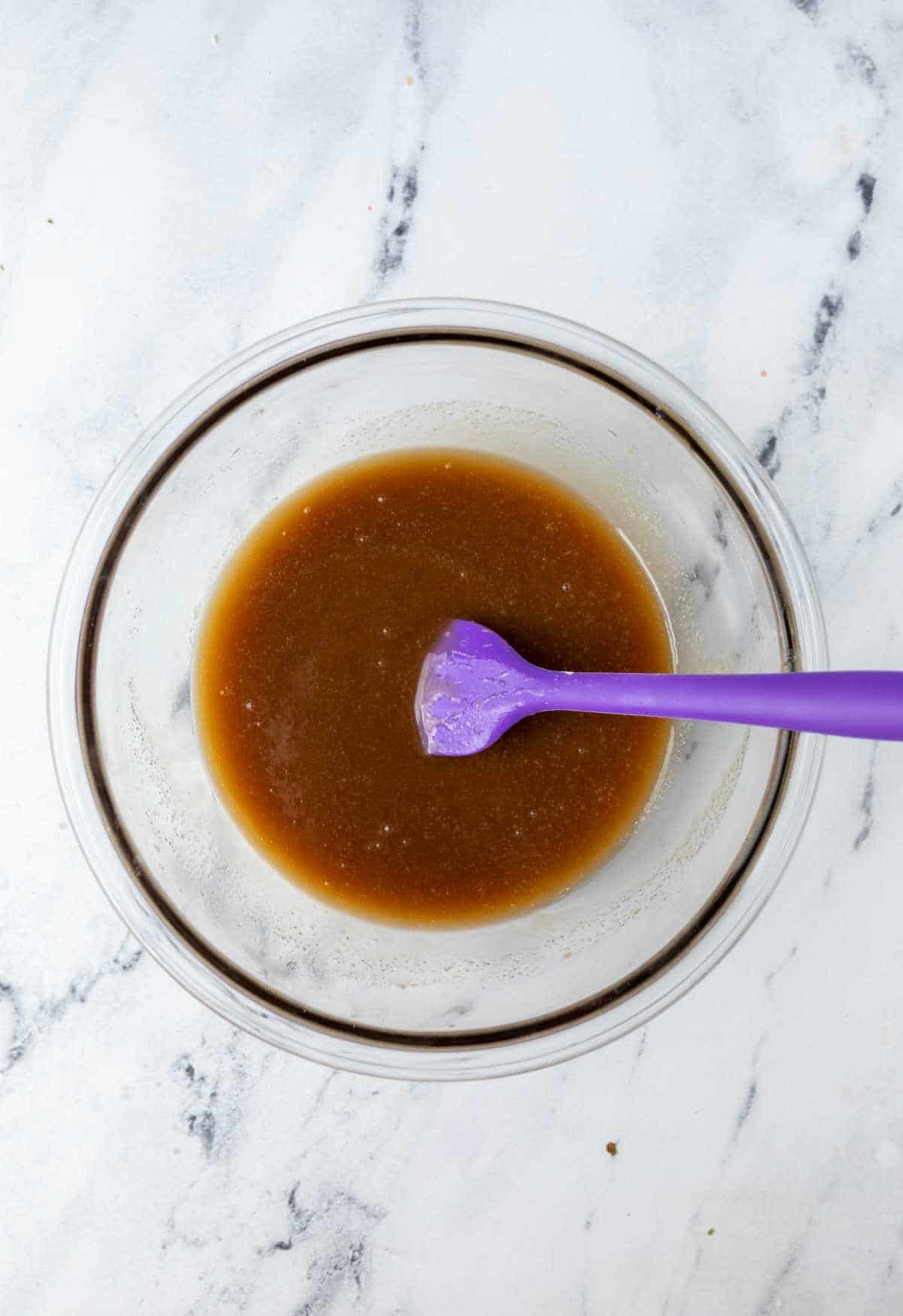 Mixed up sticky bun topping in a glass mixing bowl.