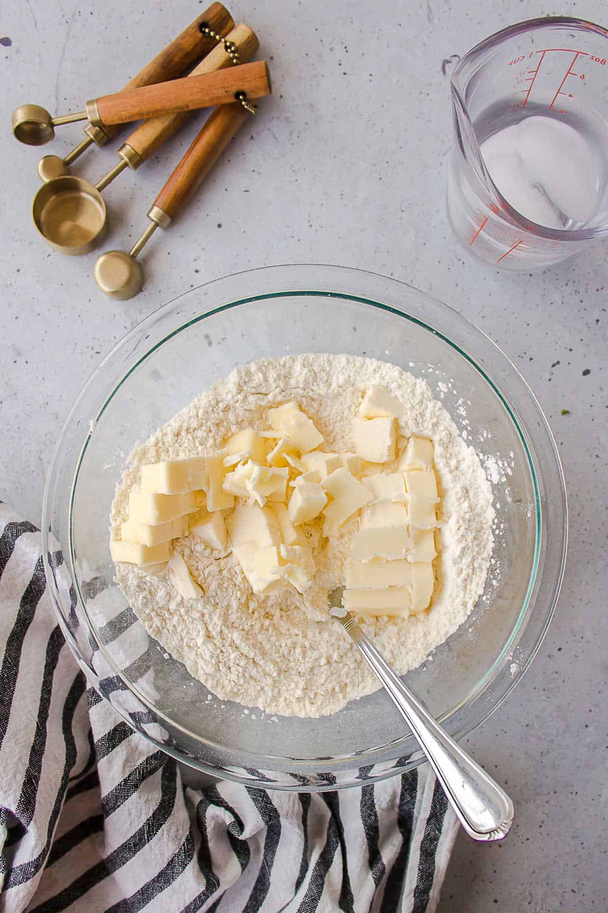 Butter cubes in a dish of flour. 