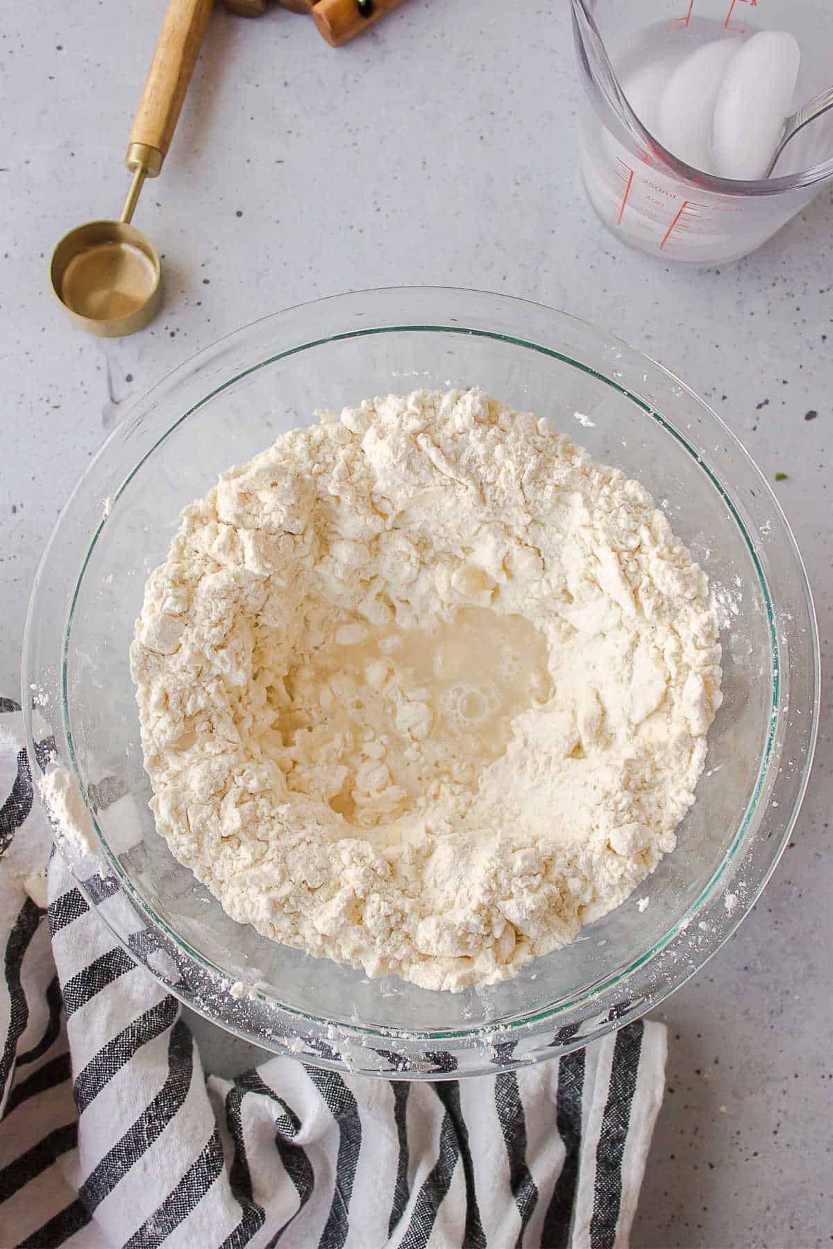 Ice water in the center of a dish of flour and butter. 