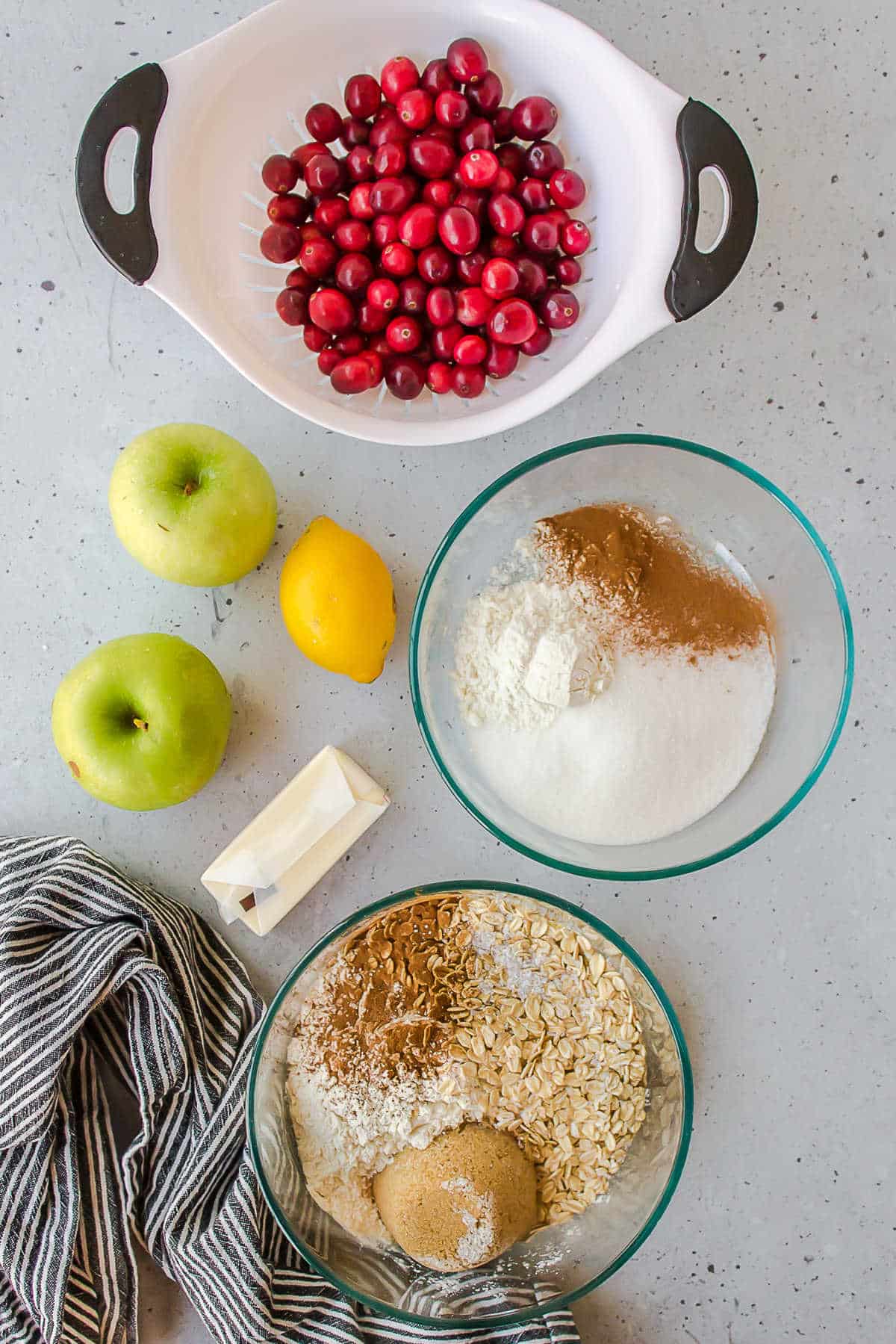 Ingredients for slow cooker cranberry apple crisp in dishes. 