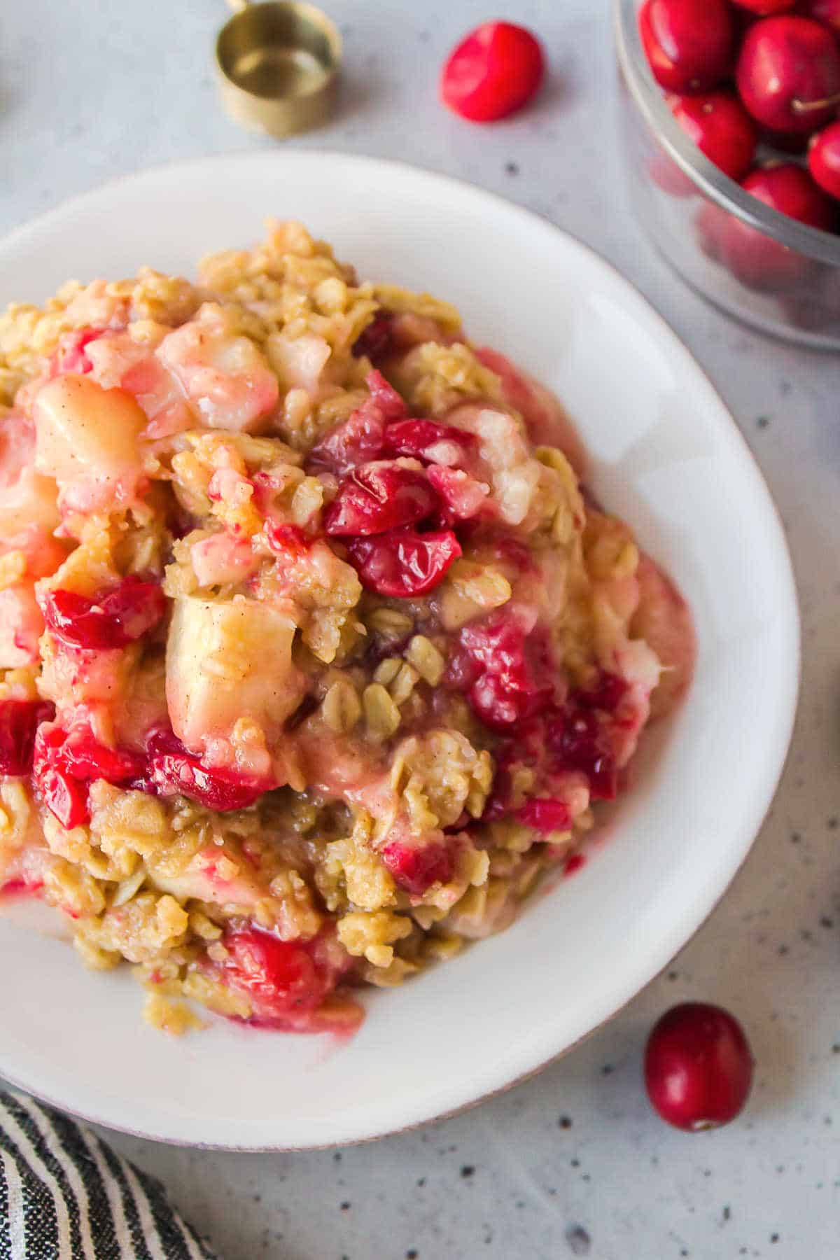 Cranberry apple crisp on a white plate. 