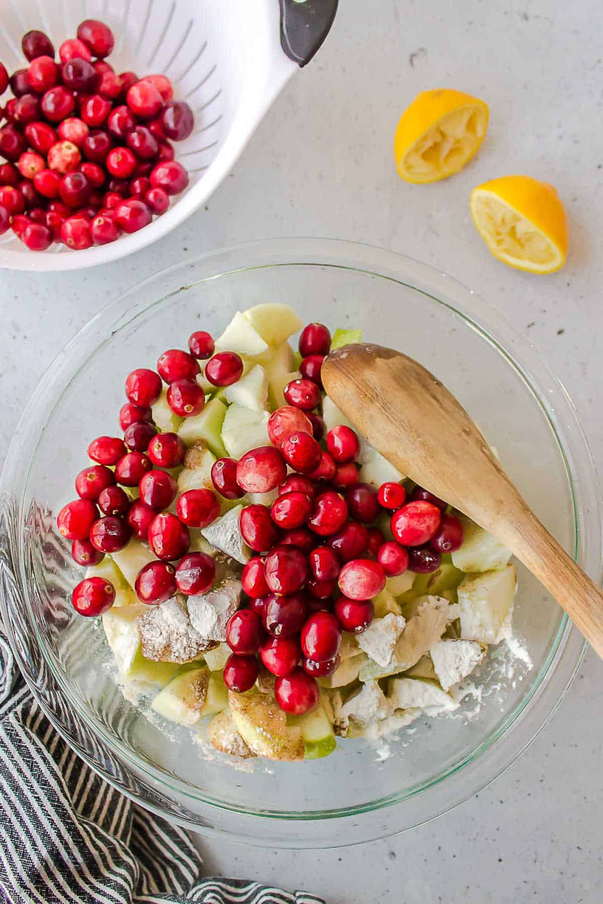 Cranberries apple slices and flour in a mixing bowl. .