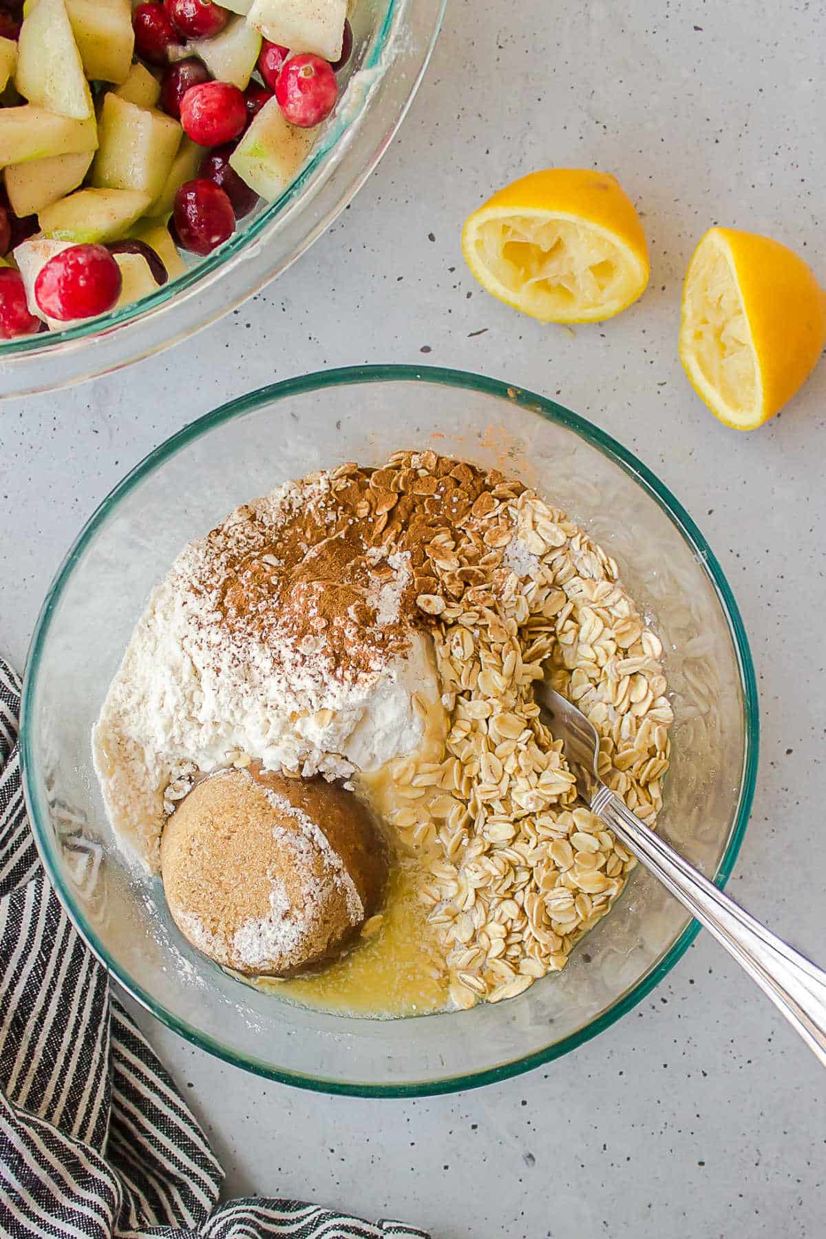 Oats flour brown sugar and spices in a glass mixing bowl.