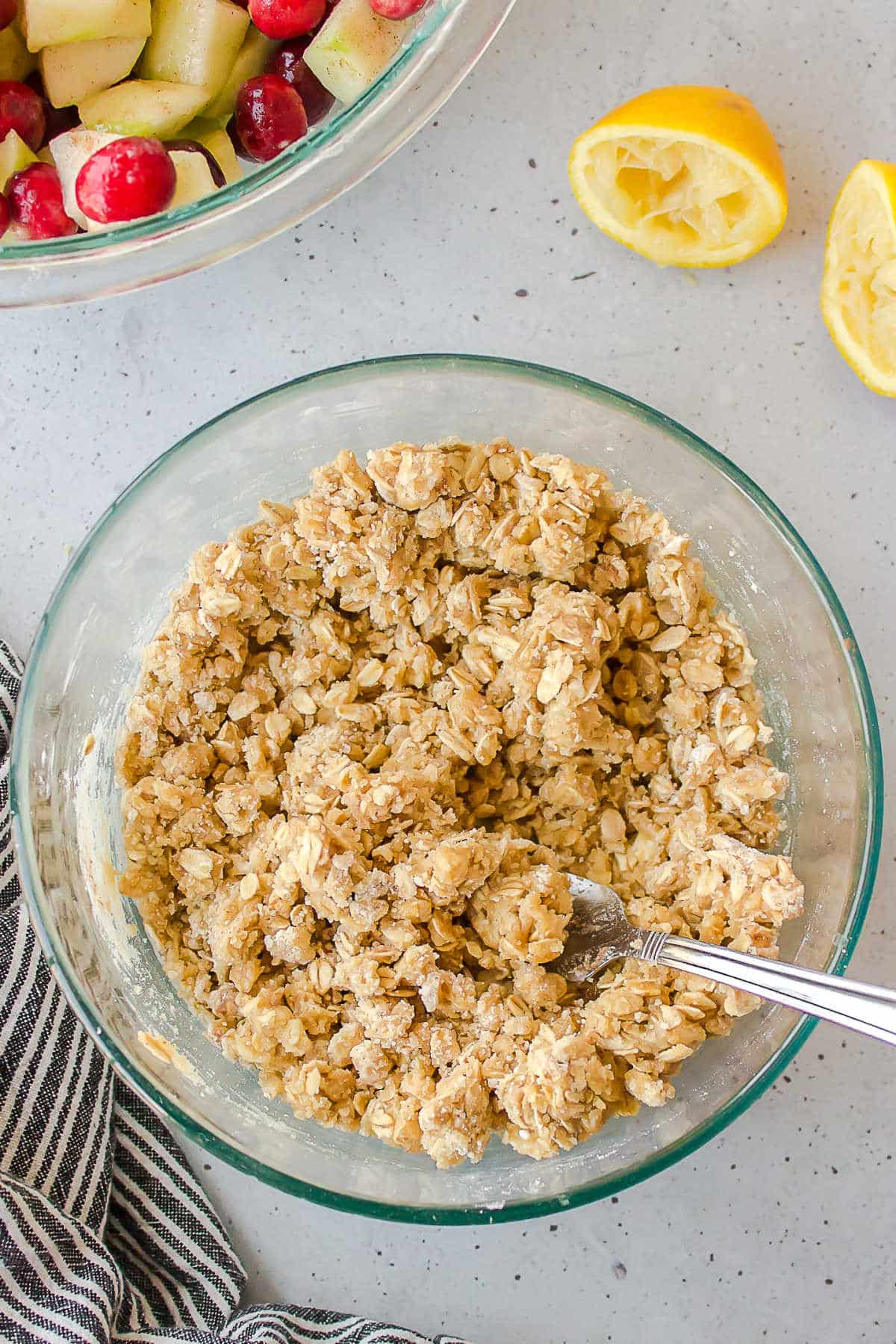 Uncooked crisp topping in a glass mixing bowl. 