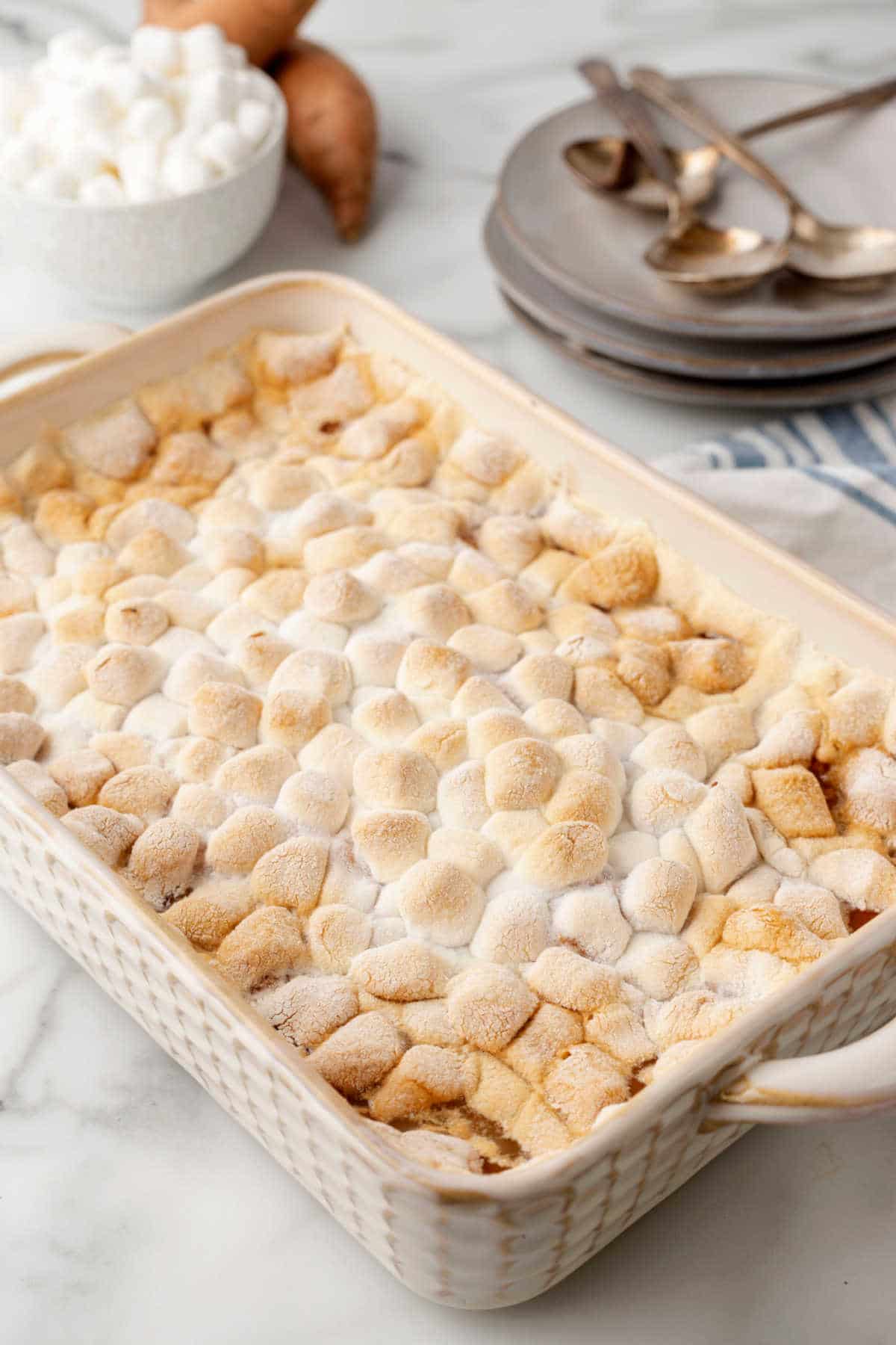 Baked sweet potato casserole topped with toasted marshmallows. 