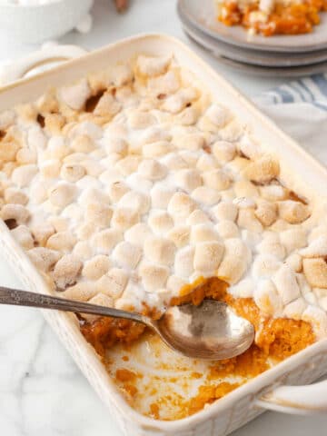 A spoon scooping out sweet potato casserole.