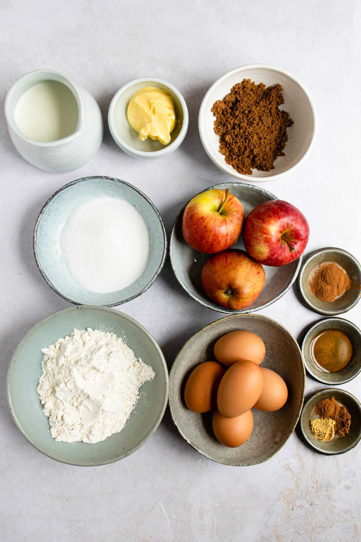 Ingredients for caramelized apple German pancakes in dishes. 