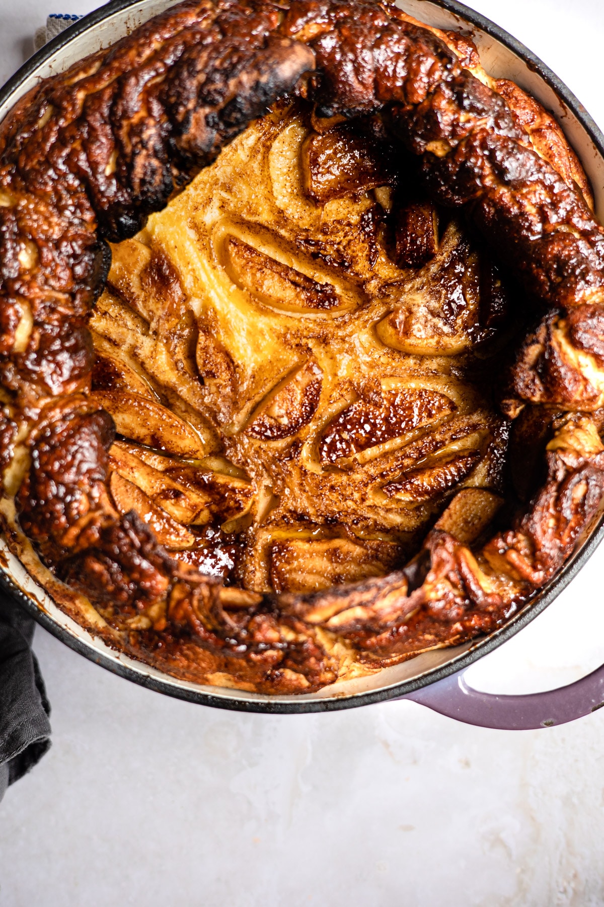 Baked caramelized apple German pancake in a pan.