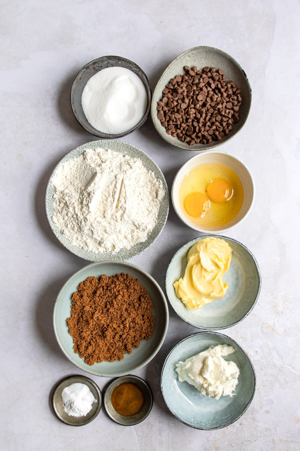 Ingredients for bakery style chocolate chip cookies in bowls. 