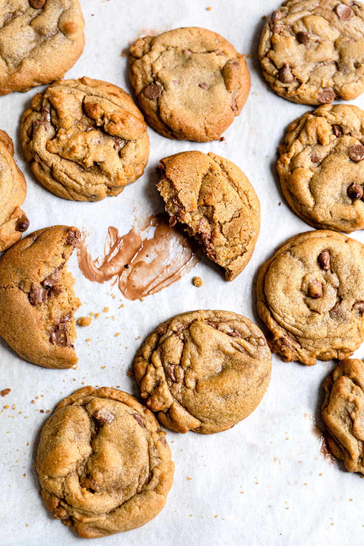 A bakery style chocolate chip cookie broken in half. 