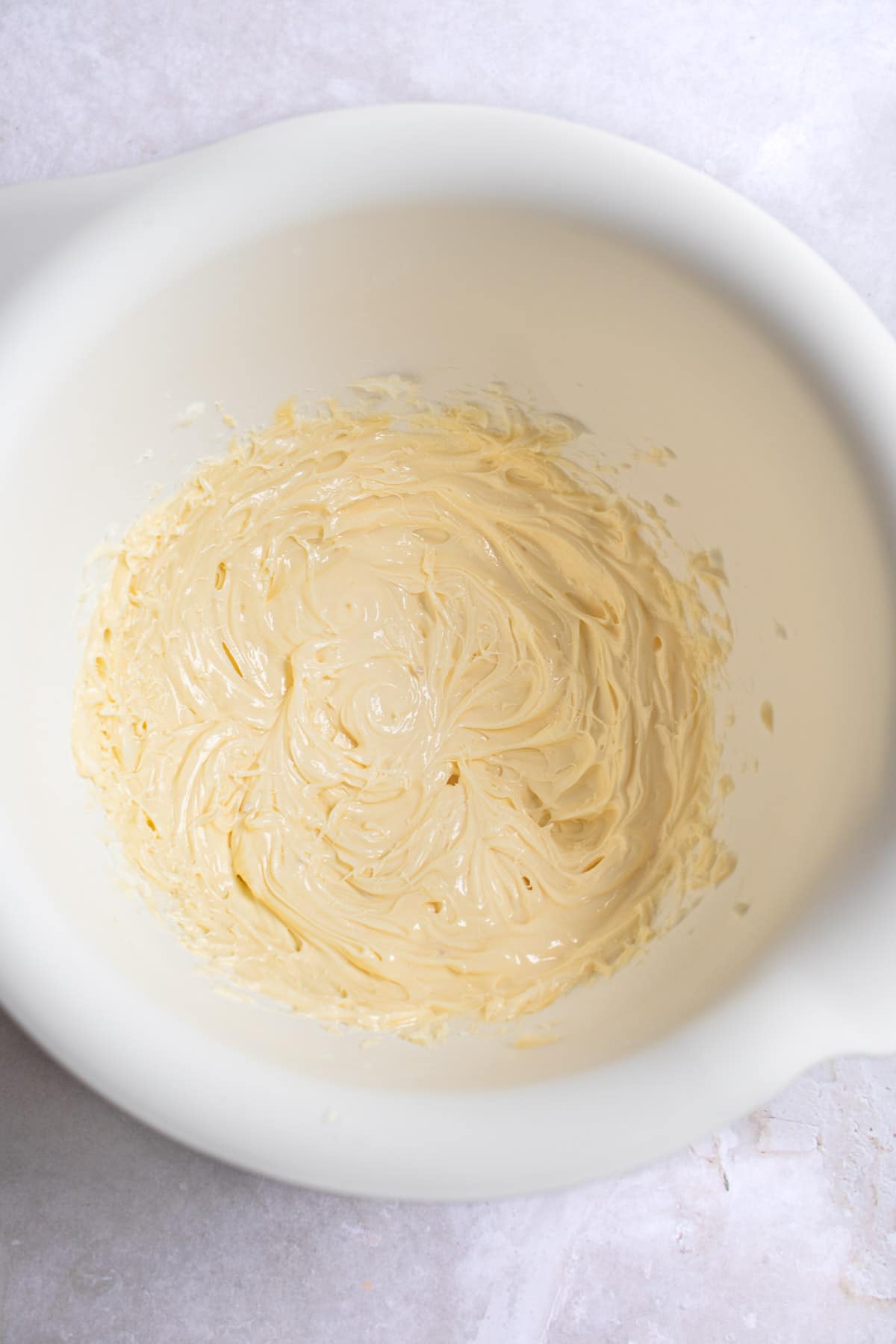 Beaten butter and shortening in a white mixing bowl. 