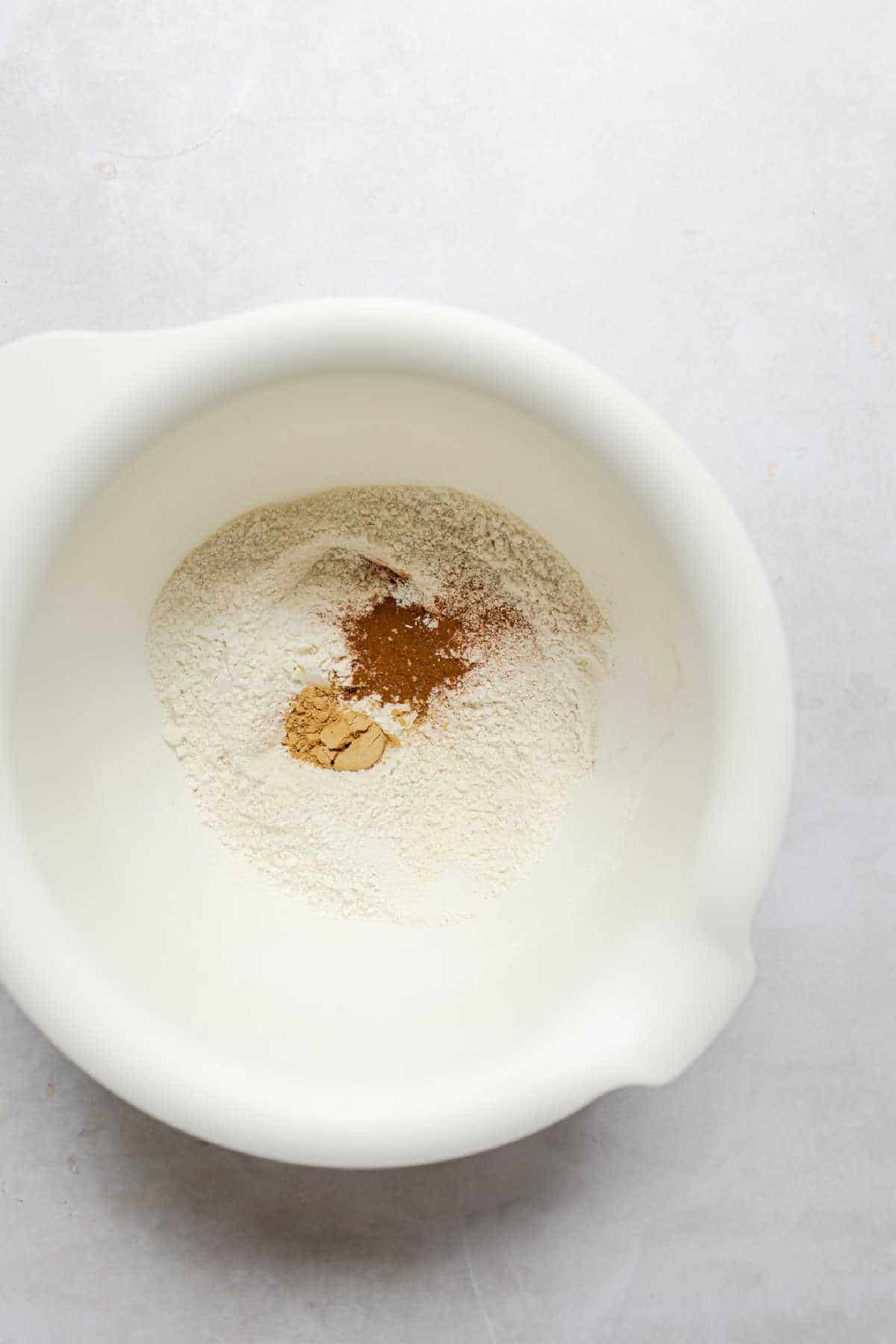 Flour and spices in a white mixing bowl. 