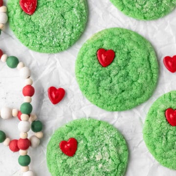 Grinch cookies on a piece of parchment paper.