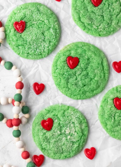 Grinch cookies on a piece of parchment paper.