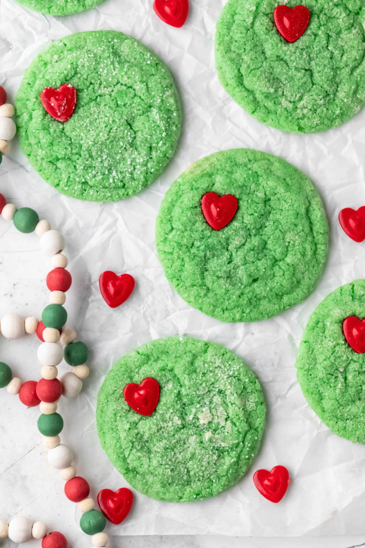 Grinch cookies on a piece of parchment paper.