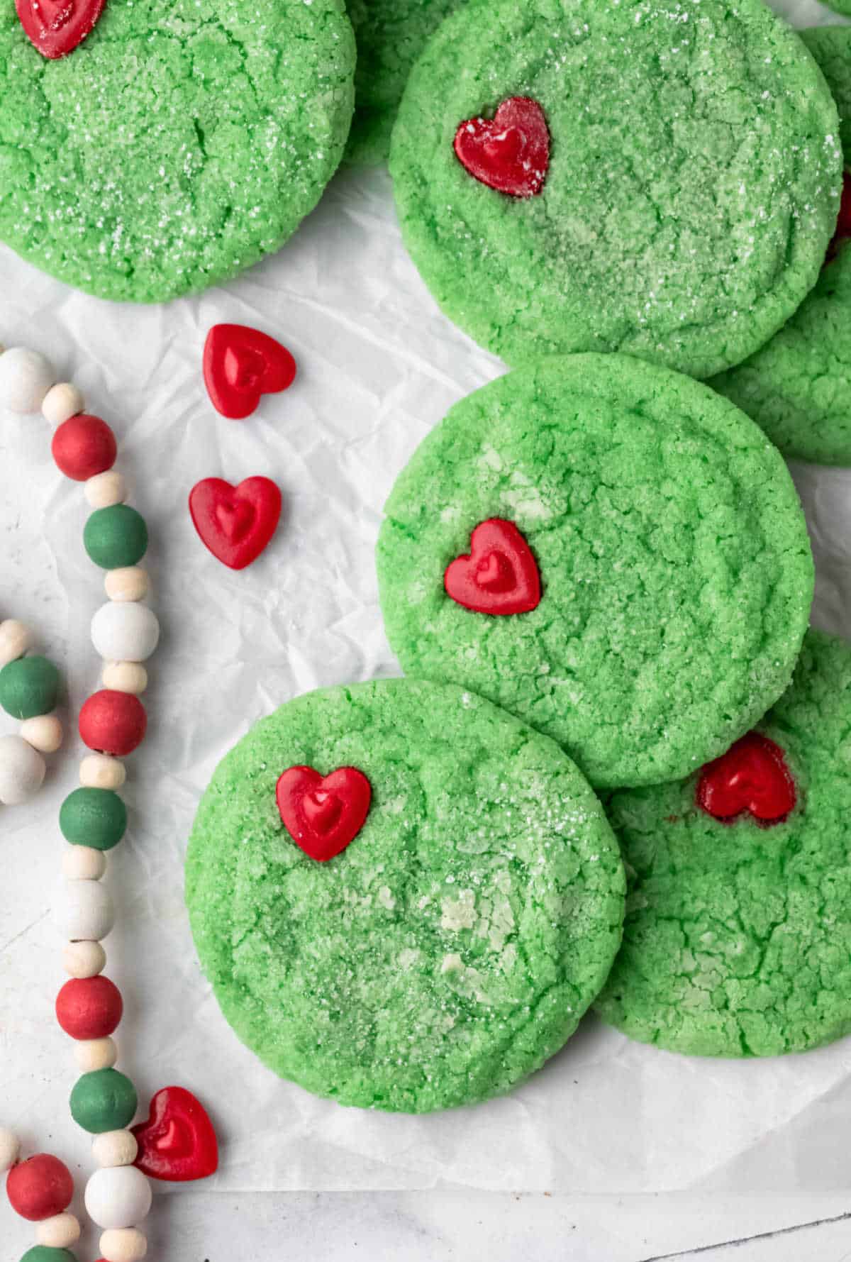 Stack of Grinch cookies on a piece of parchment paper. 