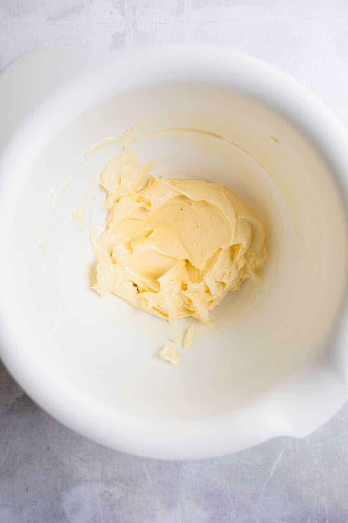 Creamed butter and shortening in a white mixing bowl. 