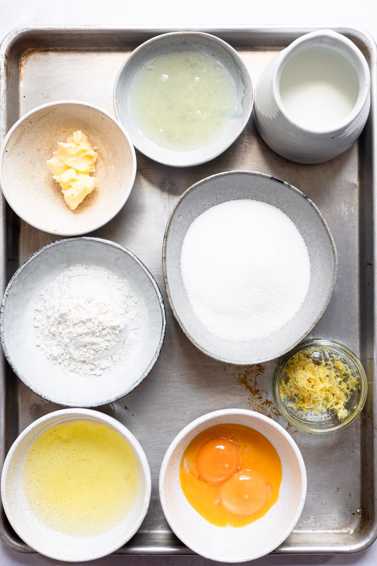 Ingredients for lemon pudding cake in dishes. 