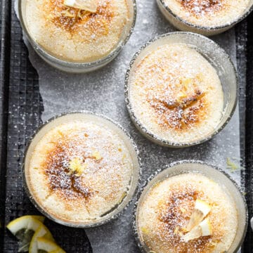 Lemon pudding cakes in glass baking dishes.