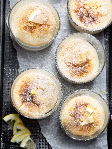 Lemon pudding cakes in glass baking dishes.