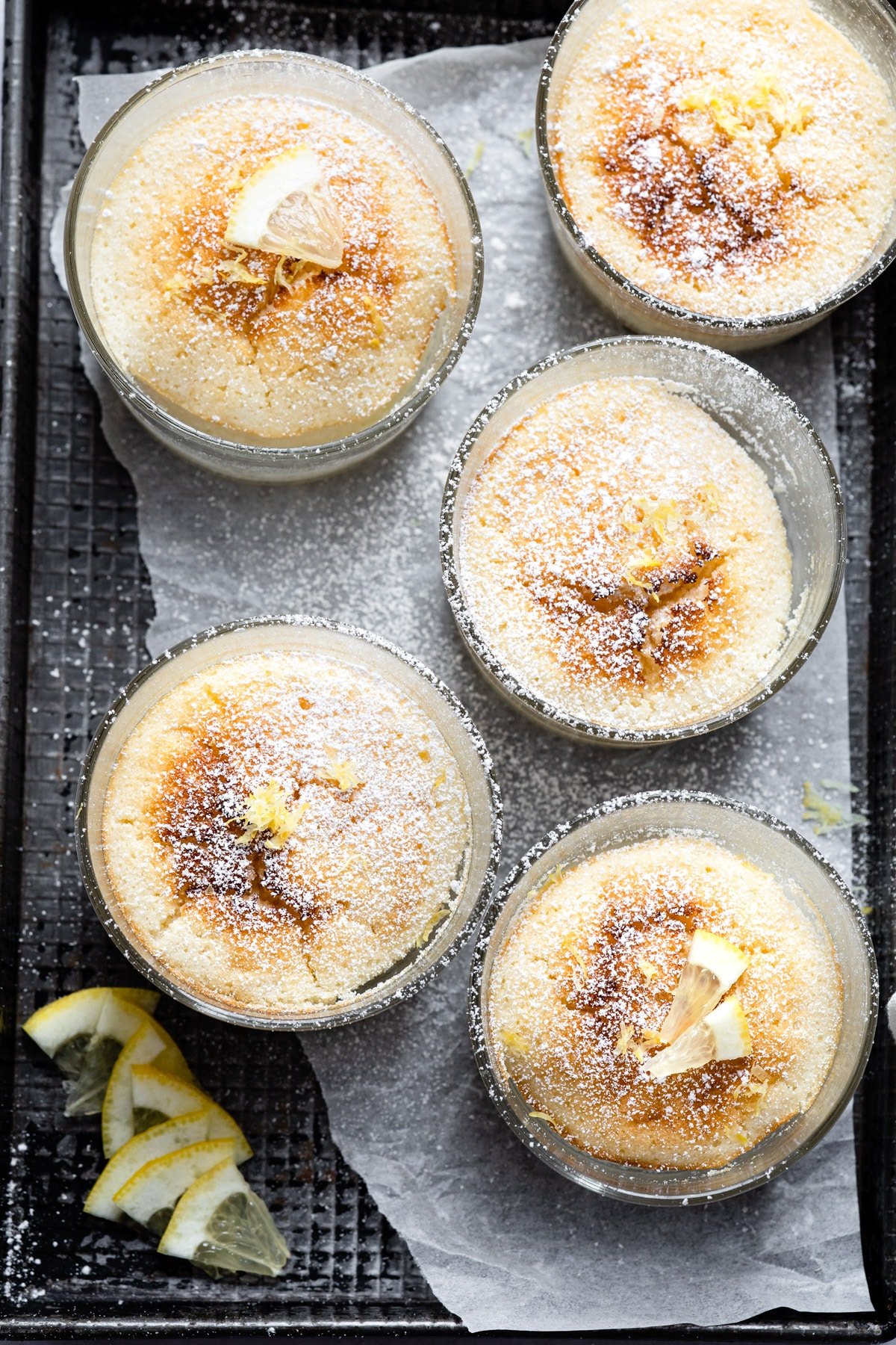 Lemon pudding cakes in glass baking dishes. 